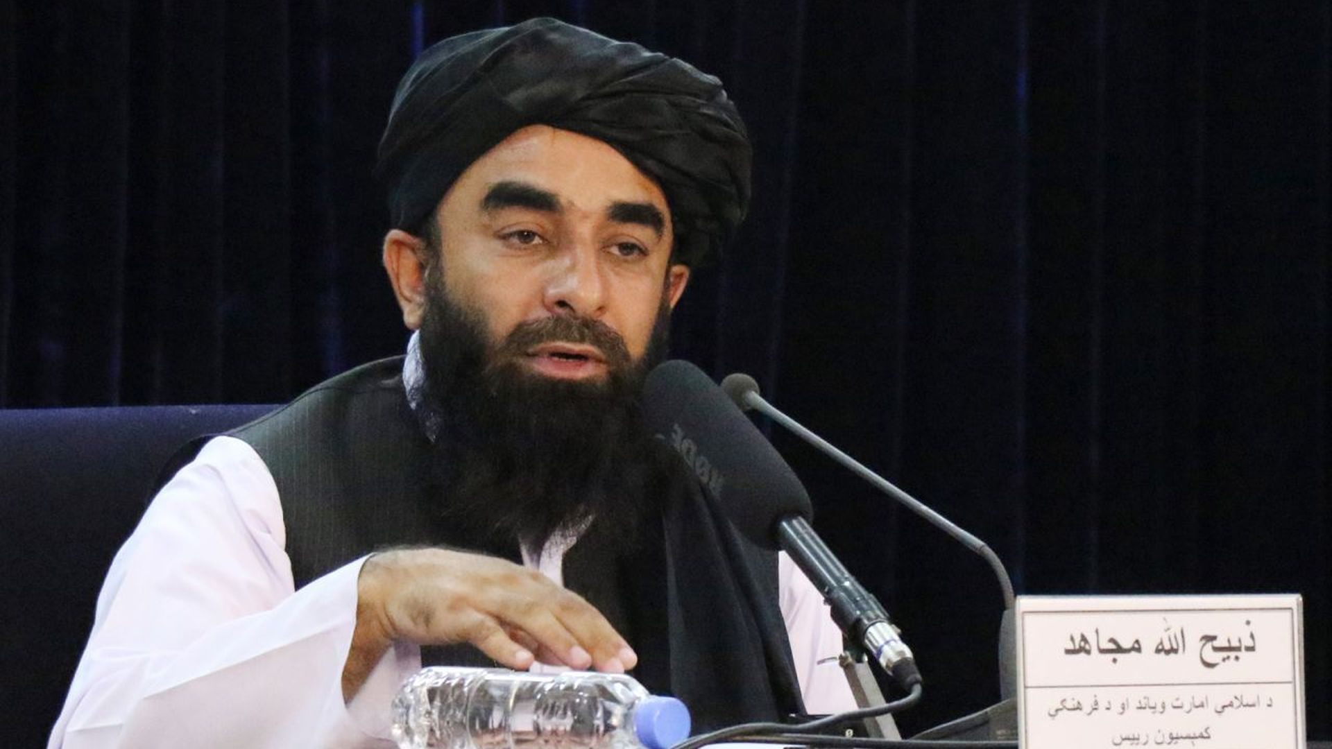 Taliban spokesperson Zabihullah Mujahid is seen holding a press conference in Kabul.