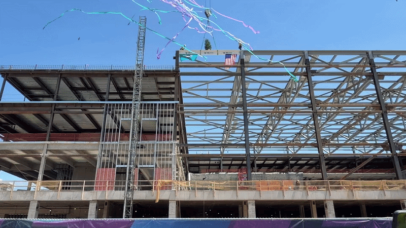 Confetti going off in front of construction on the Hornets new practice facility.