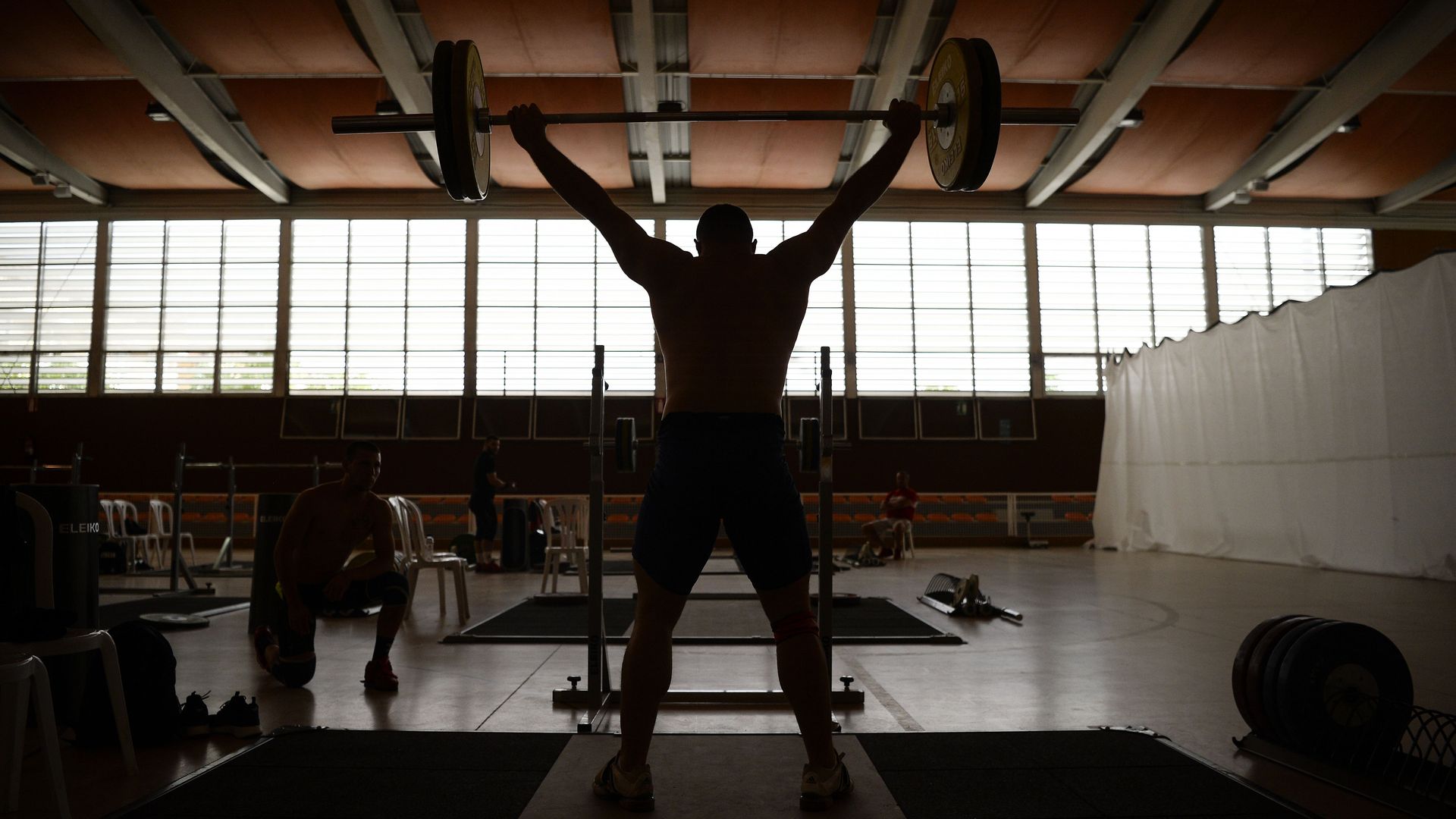 A strong man lifting weights