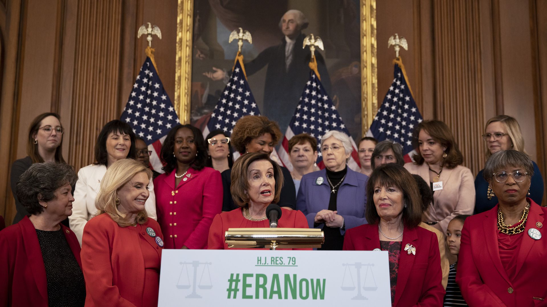 Pelosi stands with other House Democrats wearing red