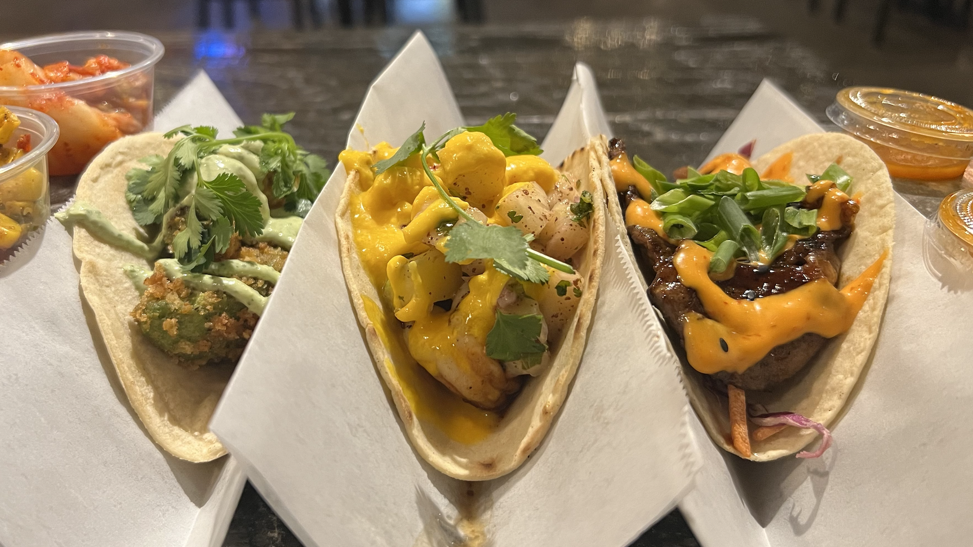 Three tacos on a serving plate