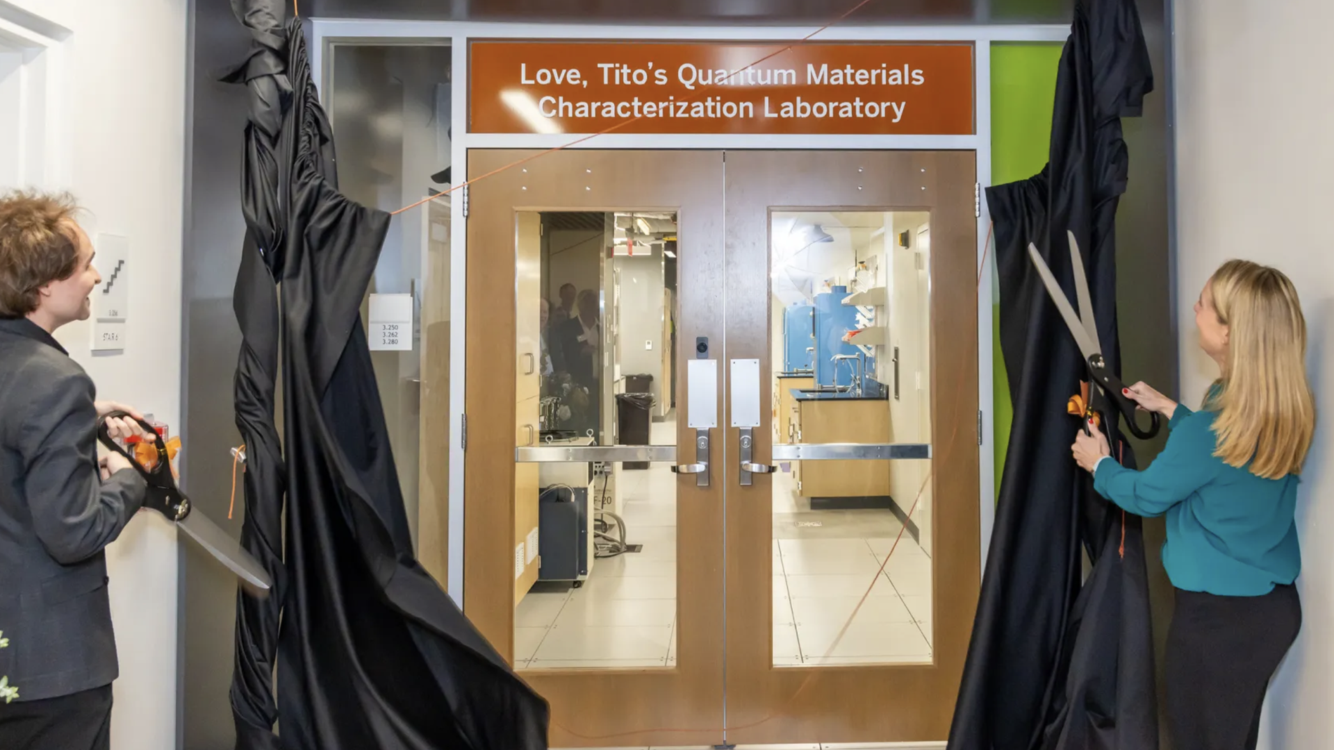 A photo of two people standing on each side of a door frame
