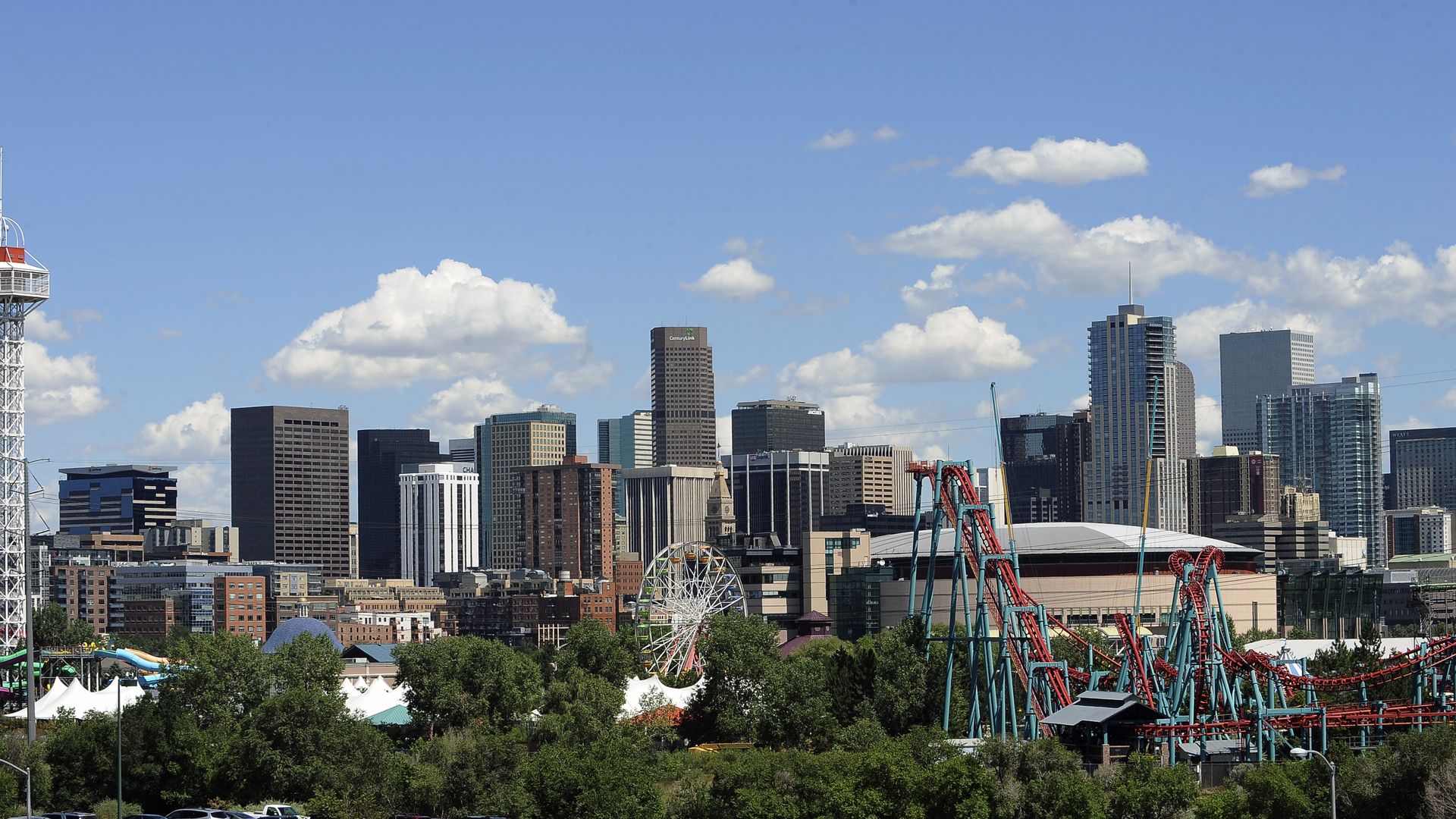 A photo of downtown Denver's skyline with Elitch Gardens in the foreground.