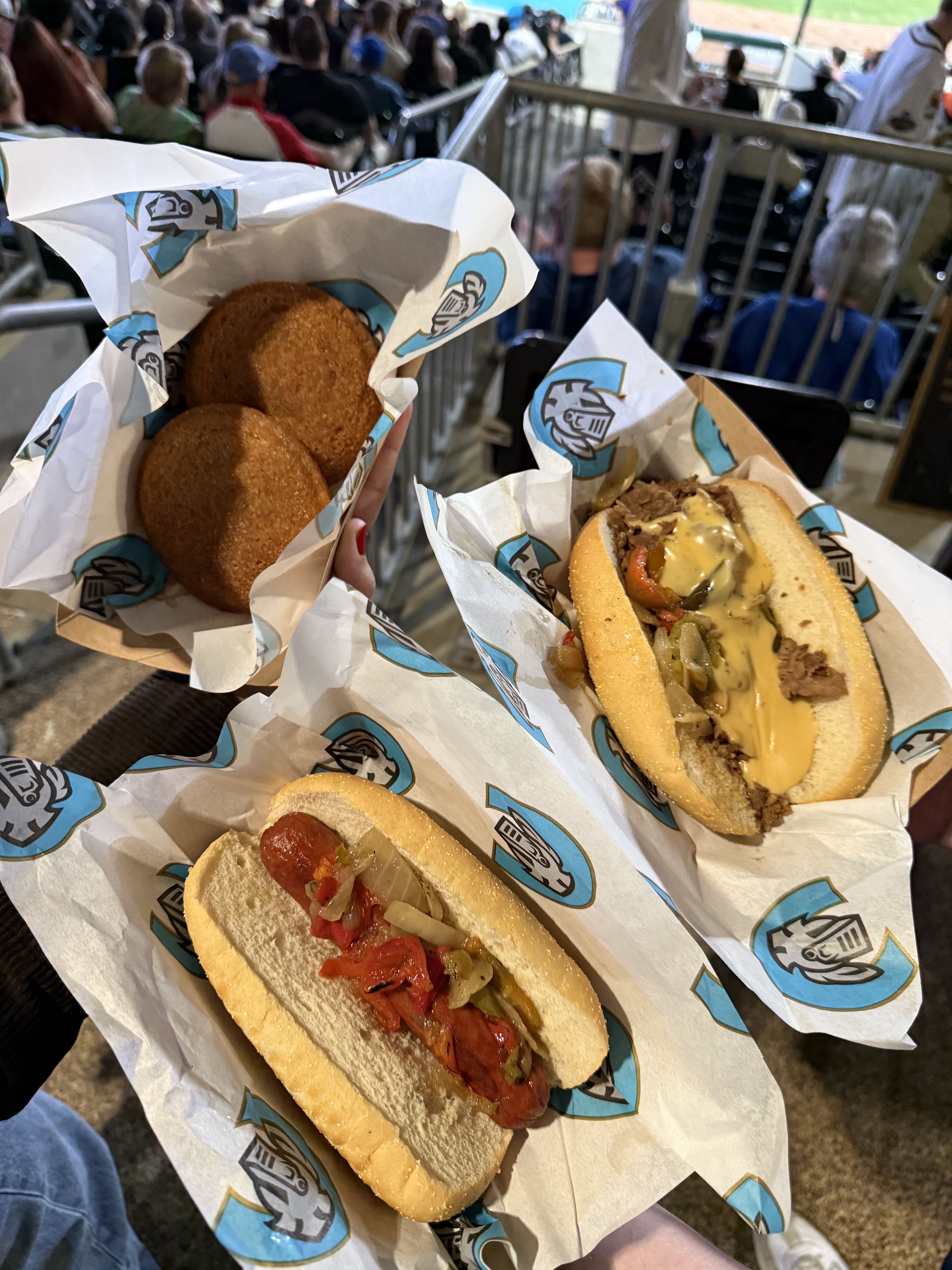 A sausage, cheesesteak, and fried treats served in branded wrappers, offering a variety of fan favorites.