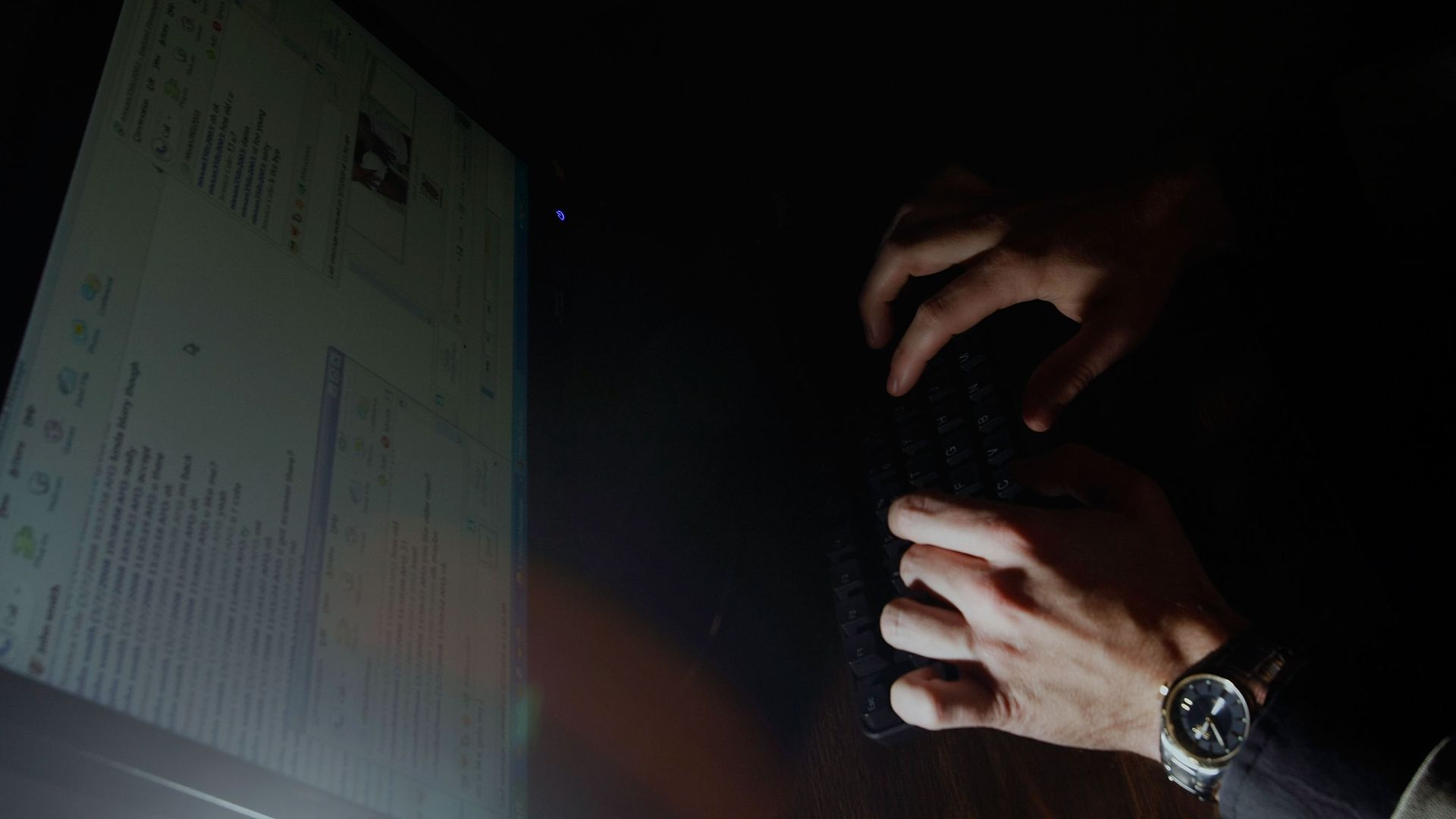 Hands typing on a keyboard.