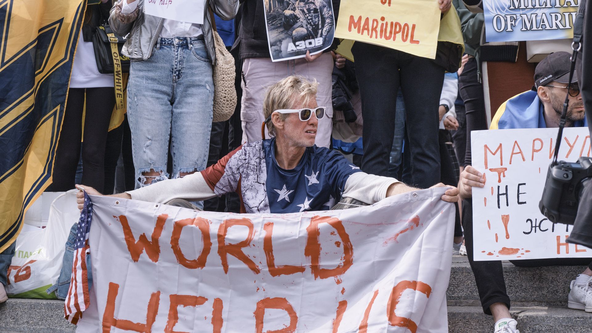 Ryan Routh holds a banner stating 'World Help Us' during a demonstration in support of Mariupol defenders 