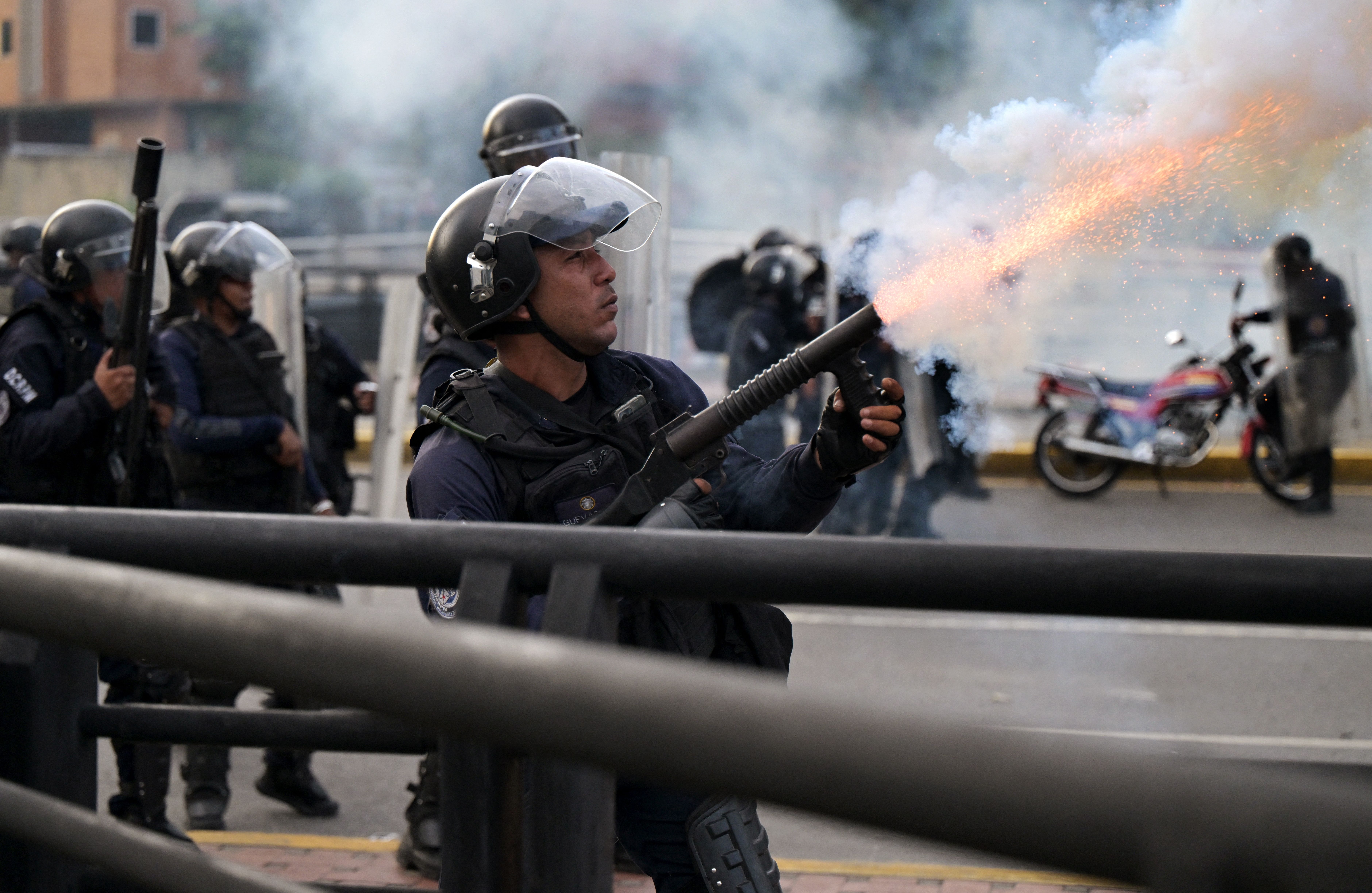  A police officer fires tear gas during a protest against President Nicolas Maduro's government in Caracas on July 29.