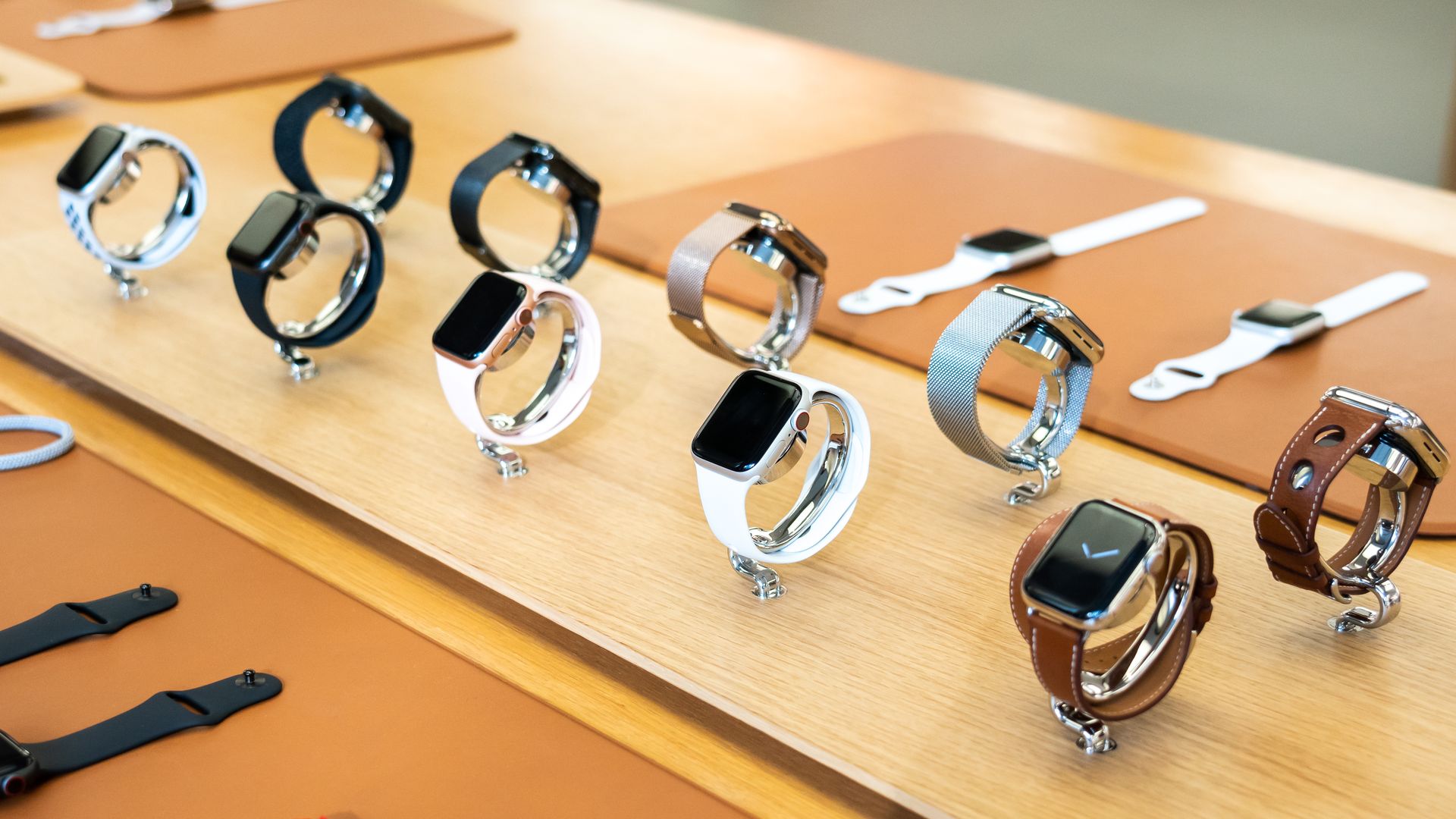 Display of Apple Watches on a wooden surface