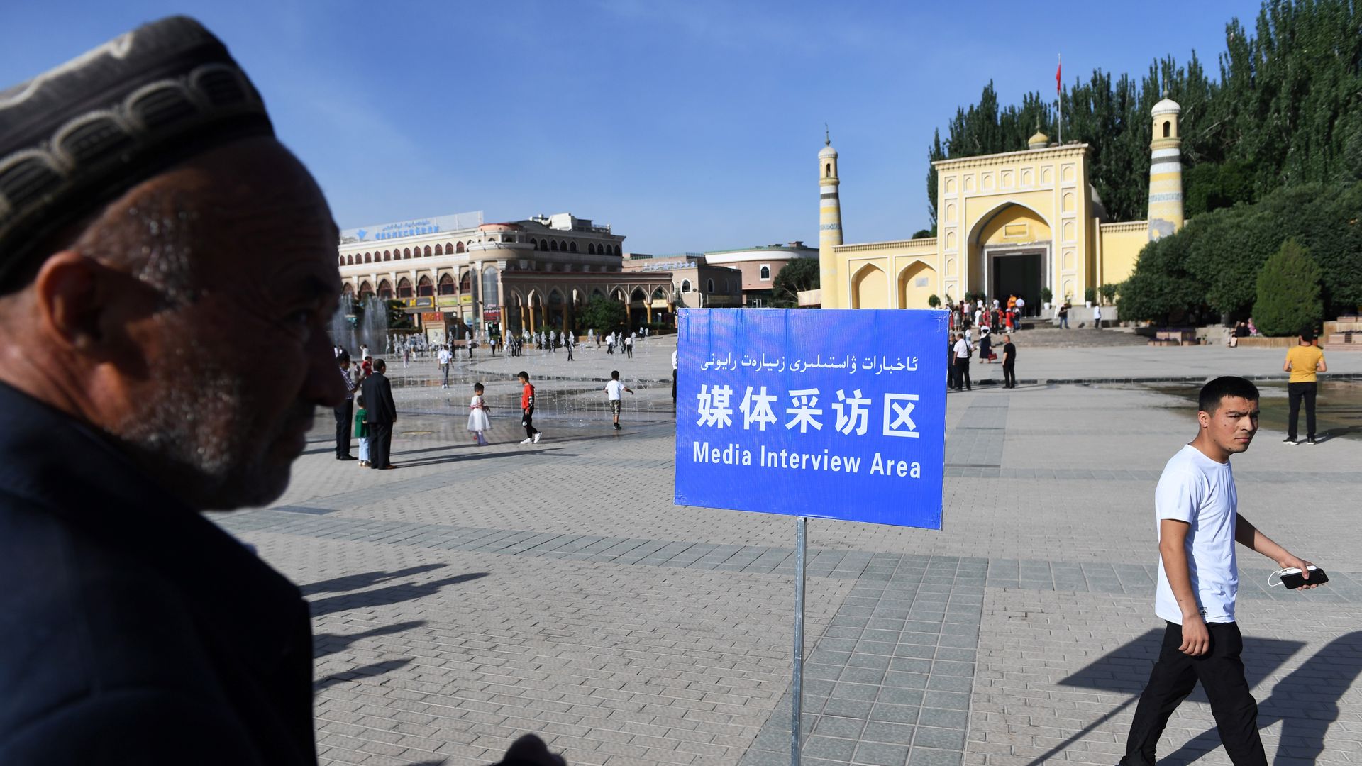 A Muslim man is near a designated media interview space in the Xinjiang region of China.