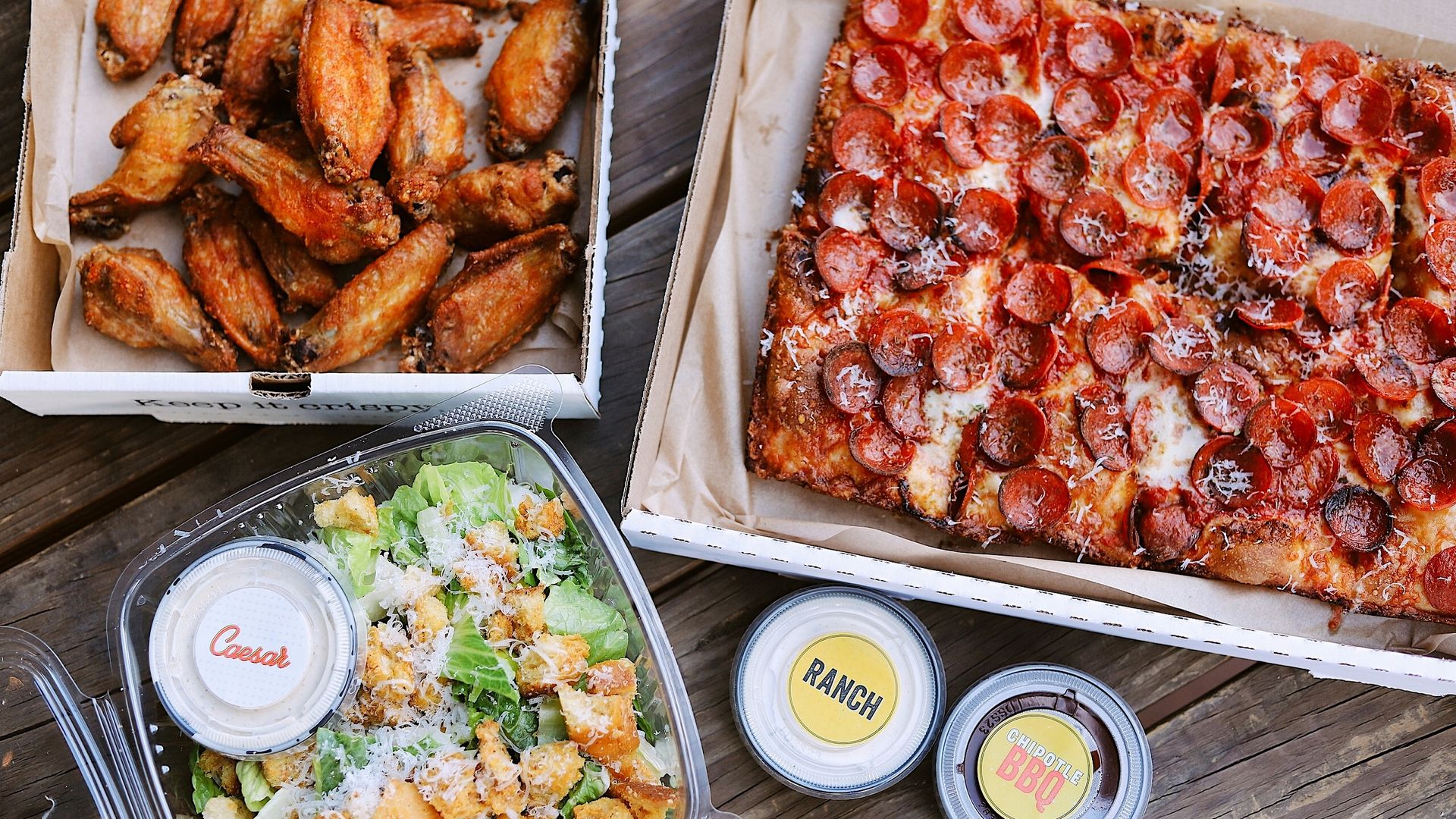 Chicken wings, salad and a Detroit-style pizza.