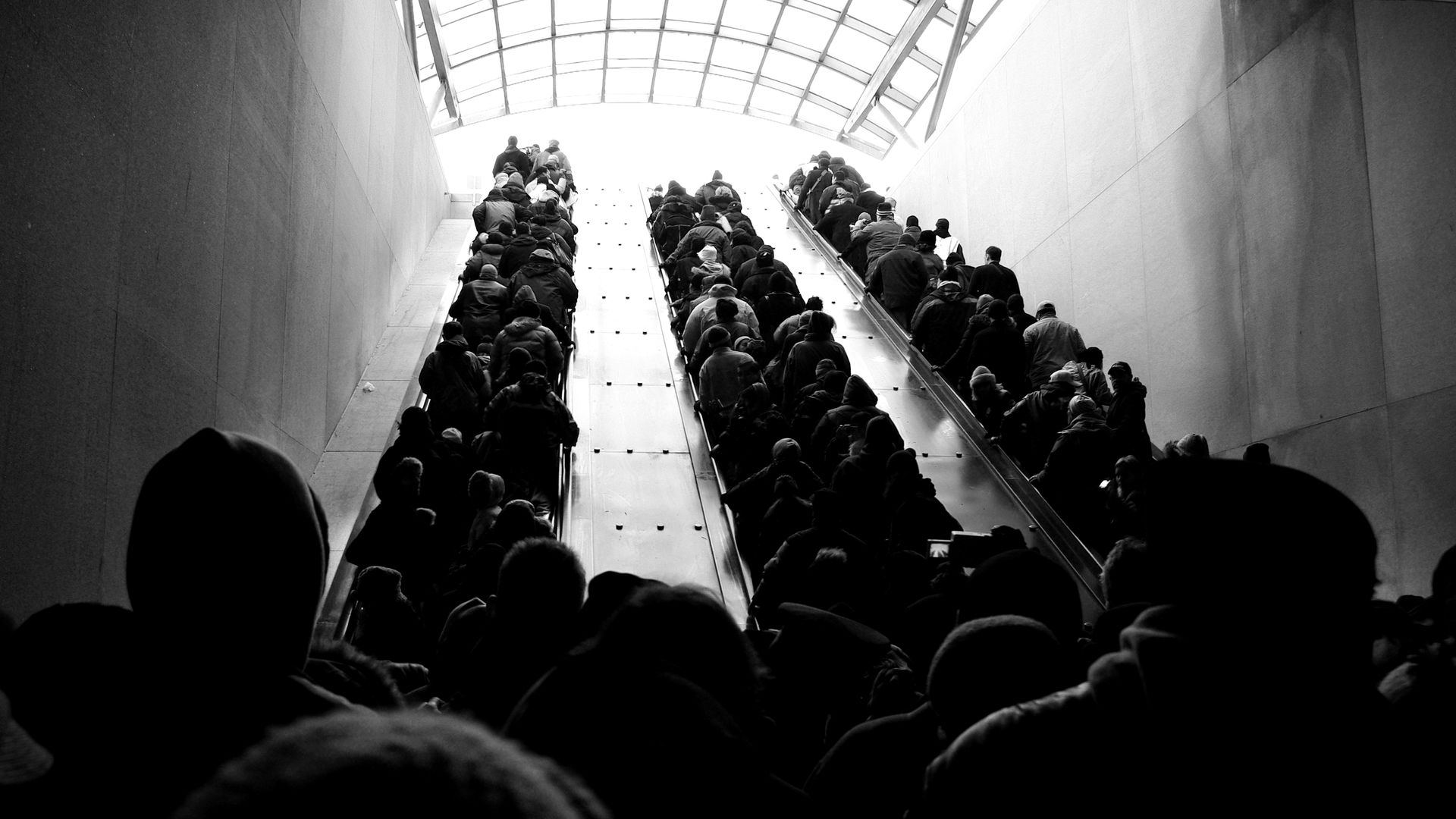 A crowded escalator out of a subway station