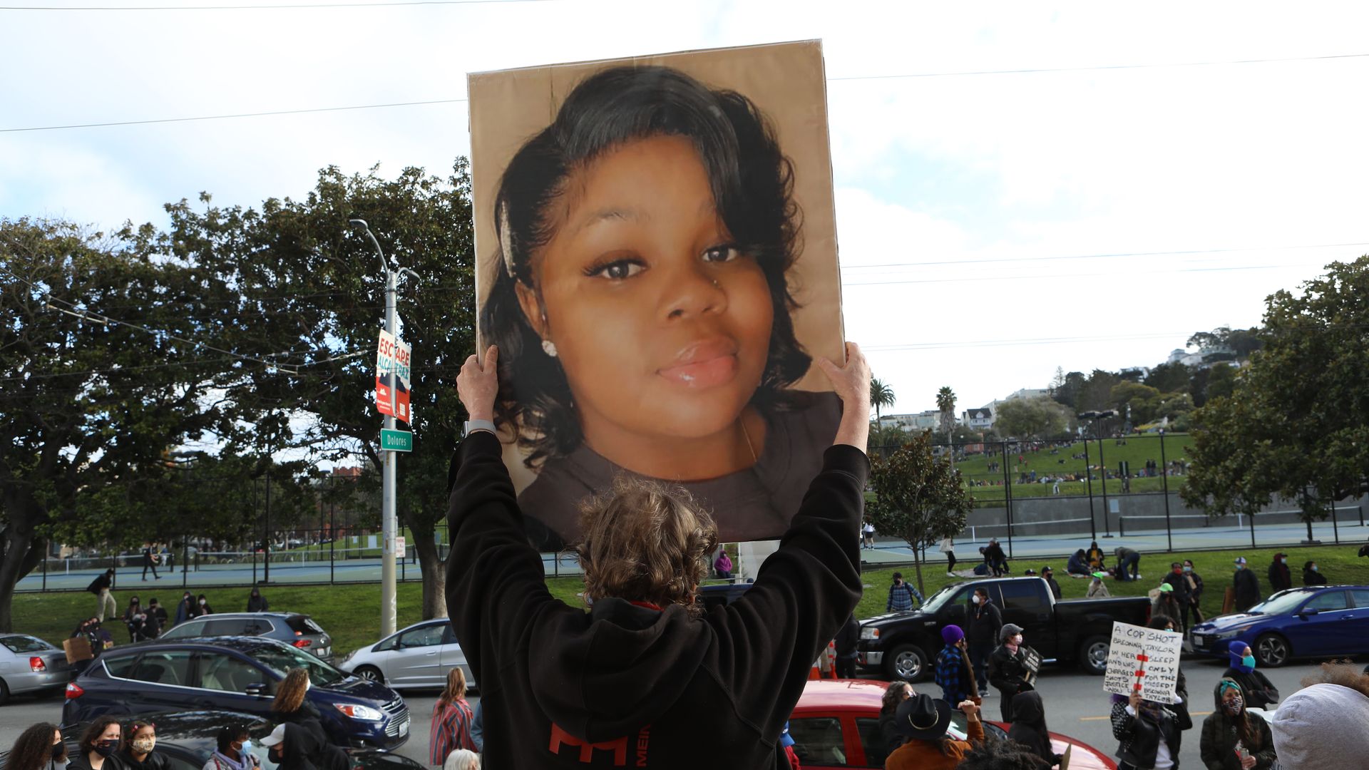 Photo of someone holding up a sign with Breonna Taylor's photo