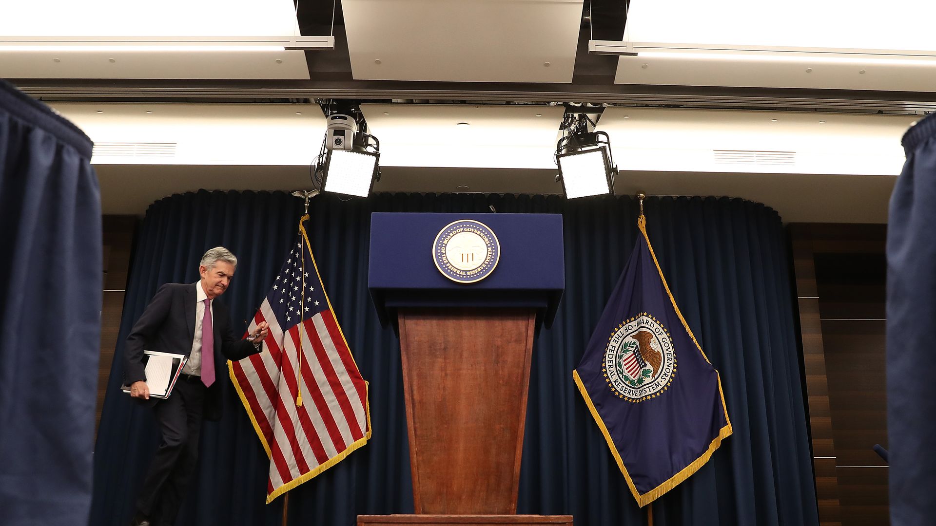 Federal Reserve Board Chairman Jerome Powell walks up to speak during a news conference.