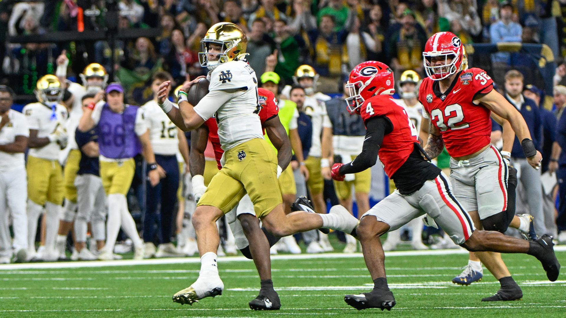  Quarterback Riley Leonard #13 of the Notre Dame Fighting Irish breaks free up the middle on a quarterback draw as Defensive Back KJ Bolden #4 of the Georgia Bulldogs defends during the Notre Dame Fighting Irish versus Georgia Bulldogs College Football Playoff Quarterfinal at the Allstate Sugar Bowl