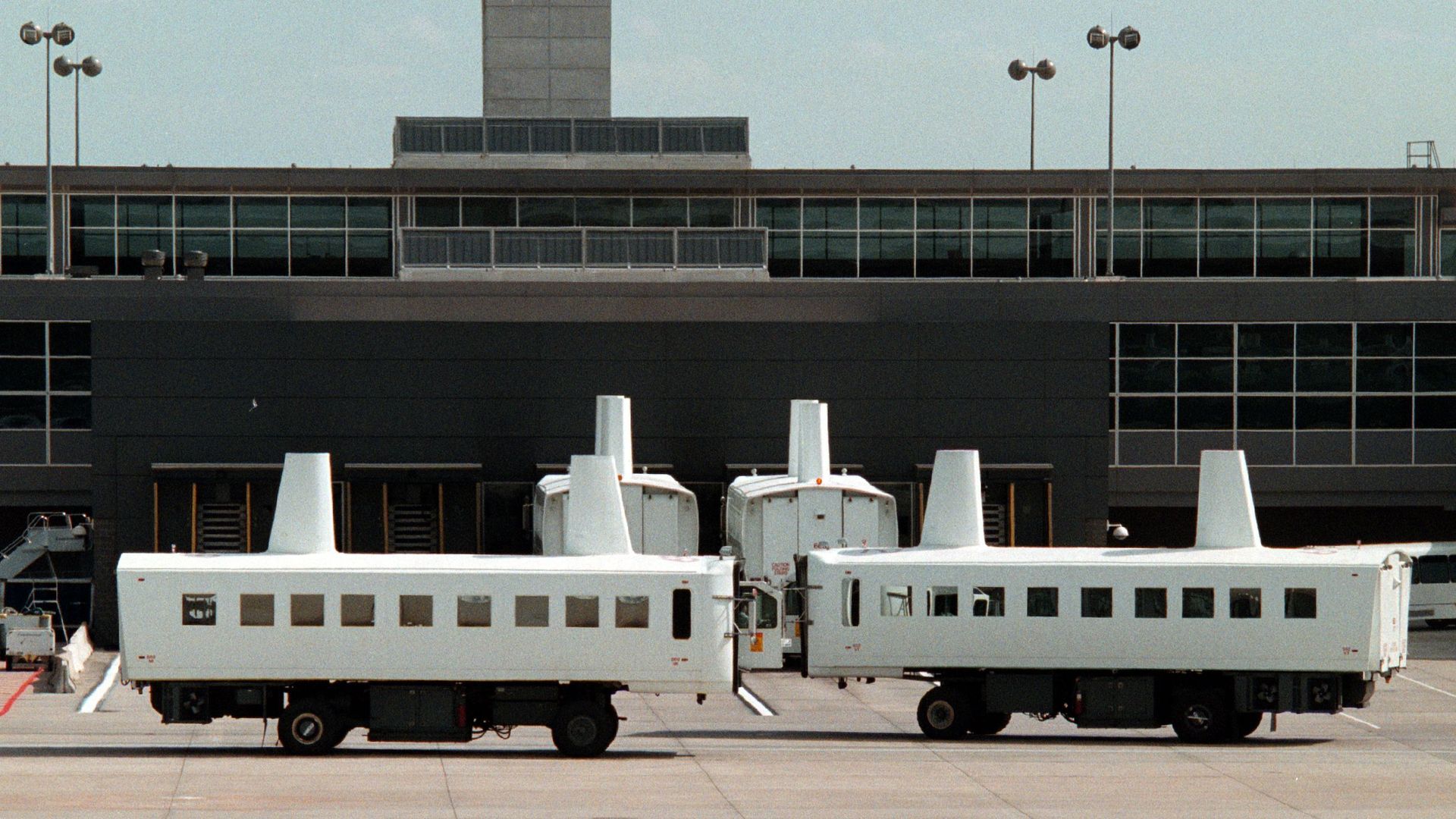A picture of the people mover / mobile lounge shuttles on the tarmac