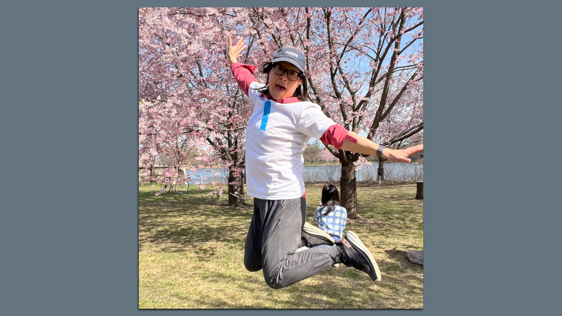 woman jumping in front of a tree