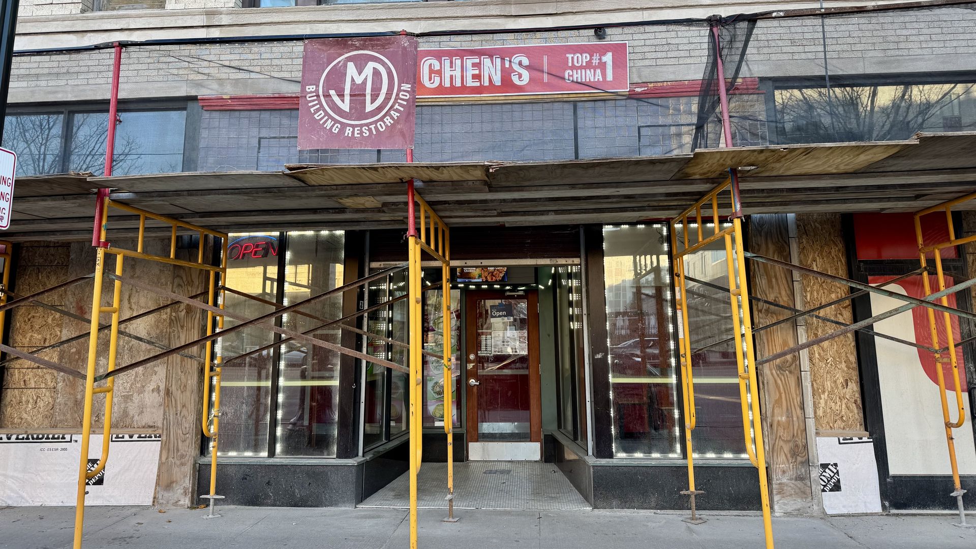The storefront with work being done on the exterior.