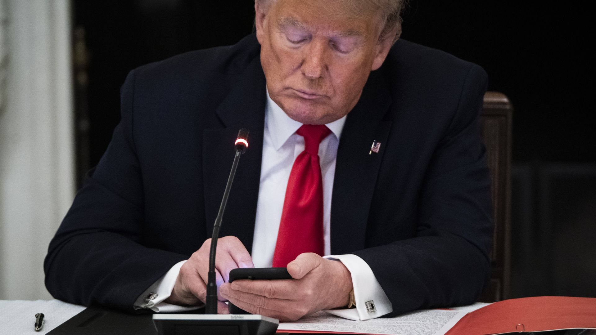 President Trump on his cellphone in June.