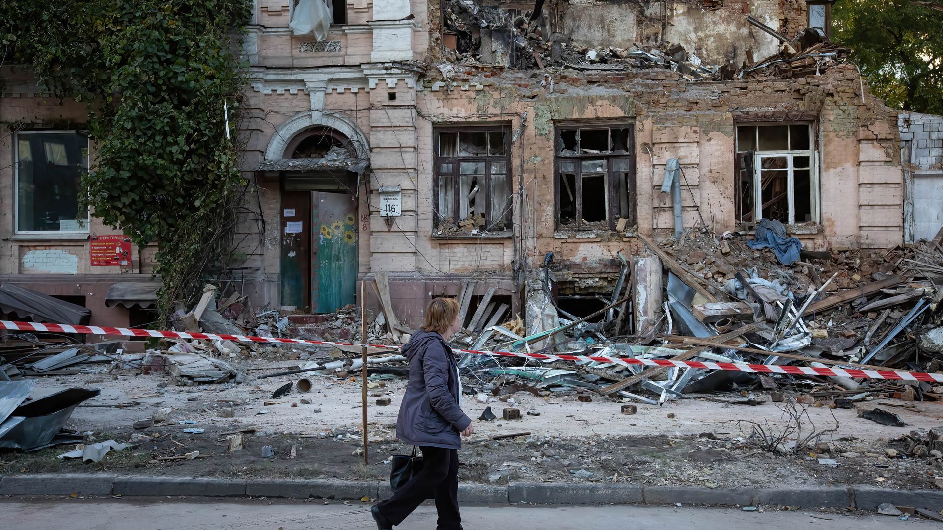  An elderly woman walks past an apartment building destroyed by a Russian drone strike, which local authorities consider to be Iranian-made unmanned aerial vehicles (UAVs) Shahed-136, in central Kyiv