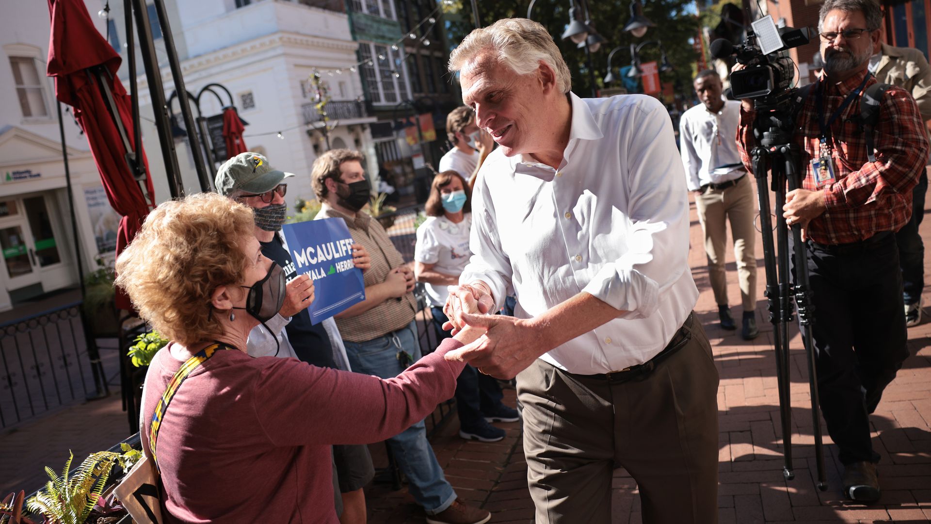Democratic gubernatorial candidate Terry McAuliffe is seen shaking hands in Charlottesville, Virginia.