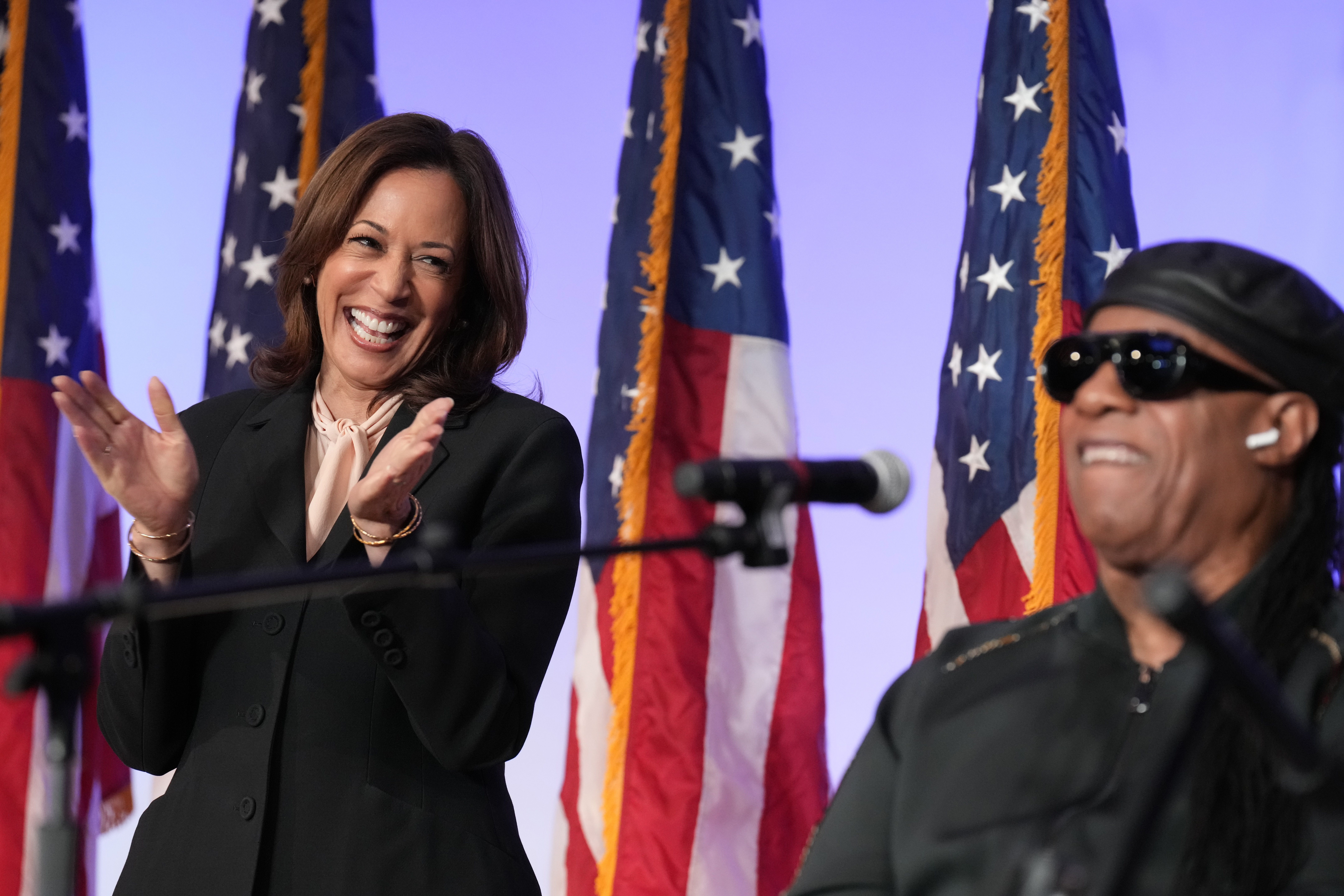 Vice President Harris listens as Stevie Wonder performs "Redemption Song" at a church yesterday in Jonesboro, Ga.