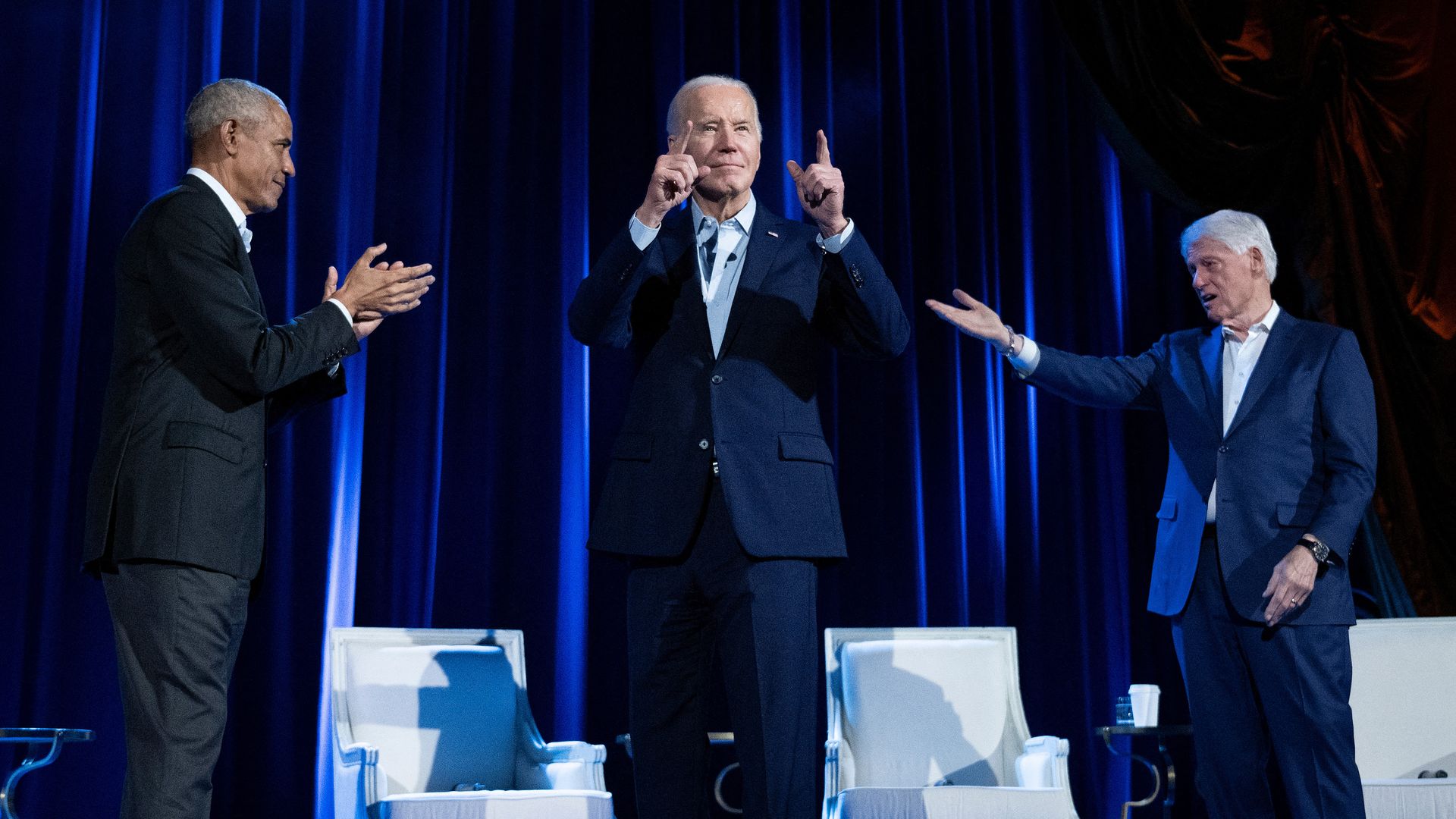 Former President Obama (L) and former President Clinton (R) cheer President Biden during a campaign fundraising event at Radio City Music Hall in New York City on March 28, 2024. 