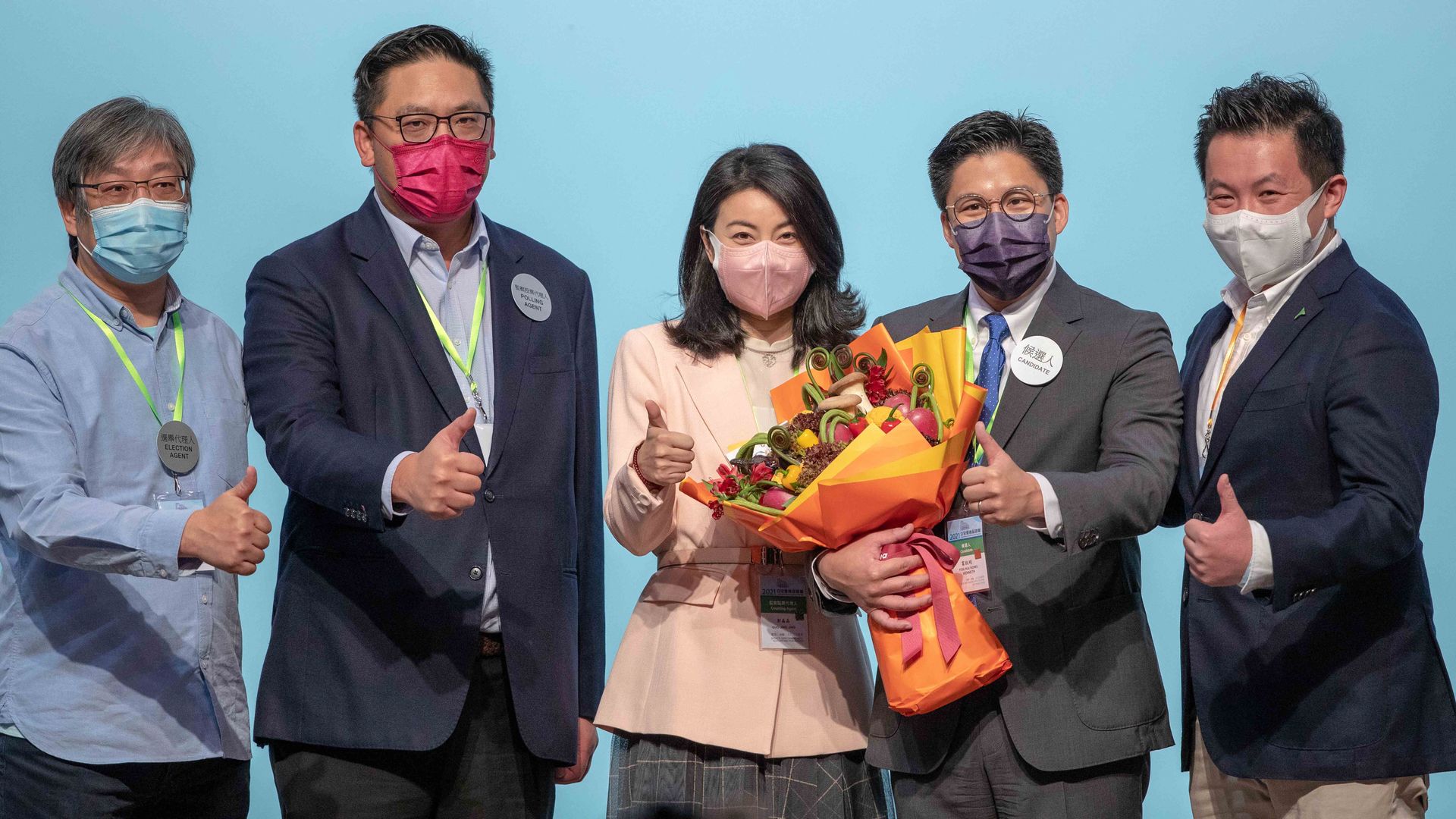 Kenneth Fok Kai-kong (L4) celebrates with wife Guo Jingjing (L3), former Olympic diving champion, after winning in the Legislative Council General Election on December 20, 2021 in Hong Kong, China.