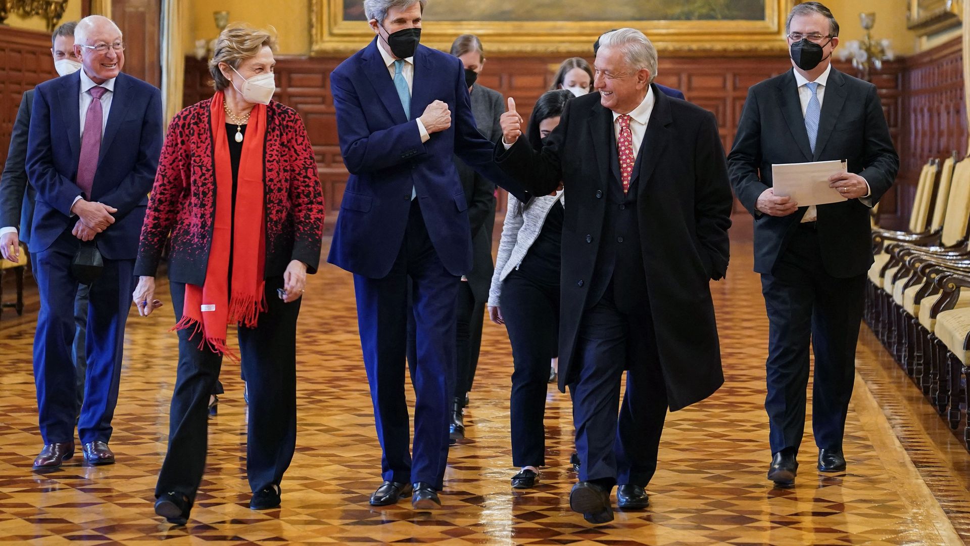 Mexican President Andres Manuel Lopez Obrador (C-R) bumping fists with U.S. Special Presidential Envoy for Climate John Kerry (C-L)