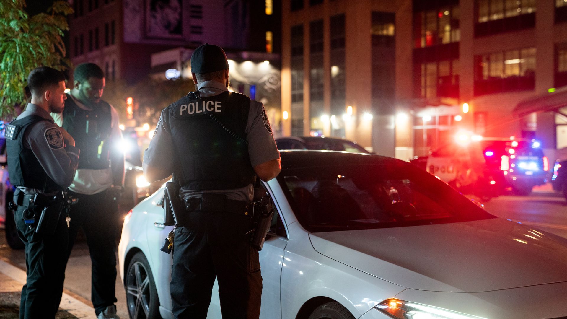 Law enforcement officers near a stopped vehicle on U Street in D.C.
