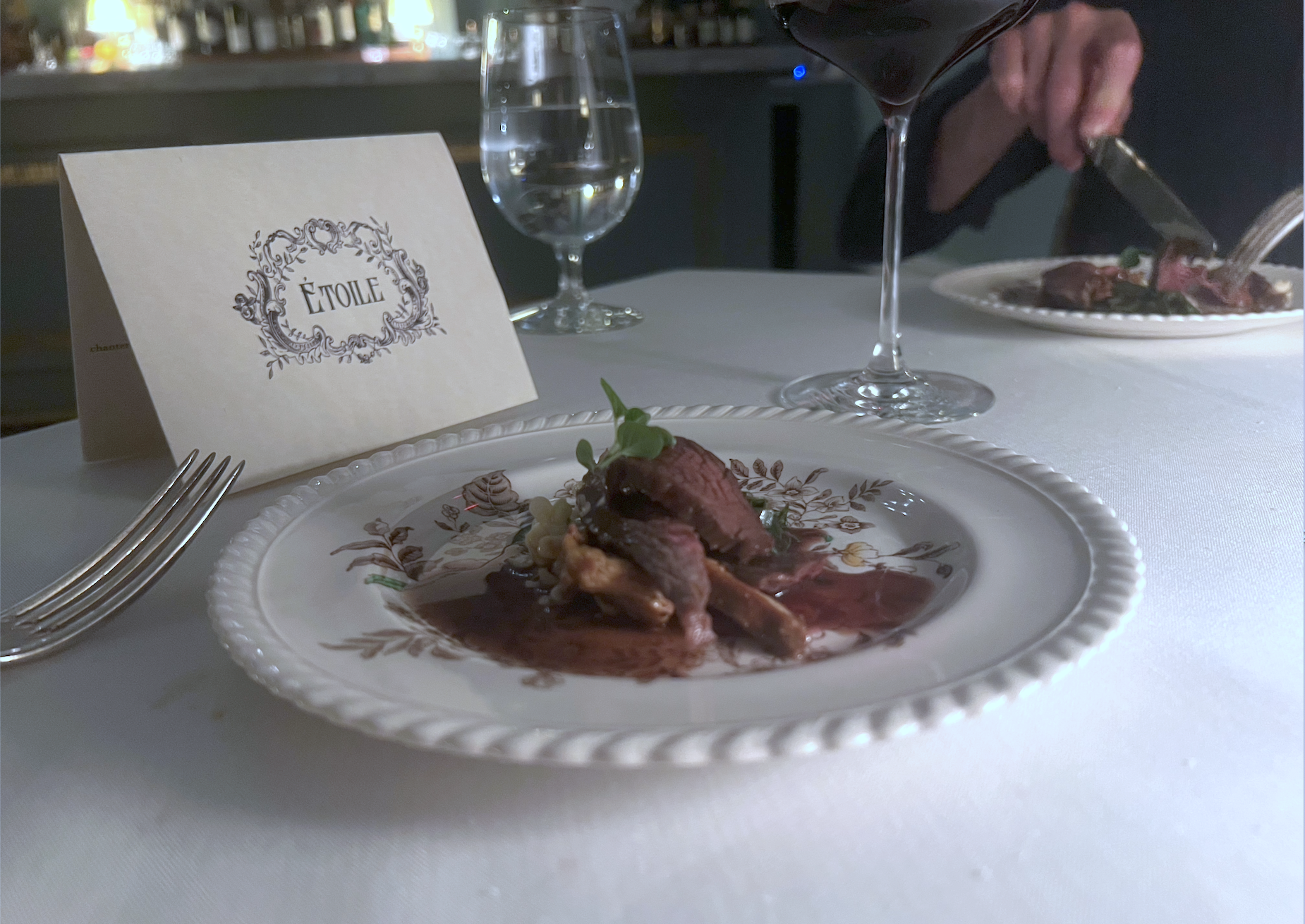 A small white plate has pieces of wagyu beef strips on it.