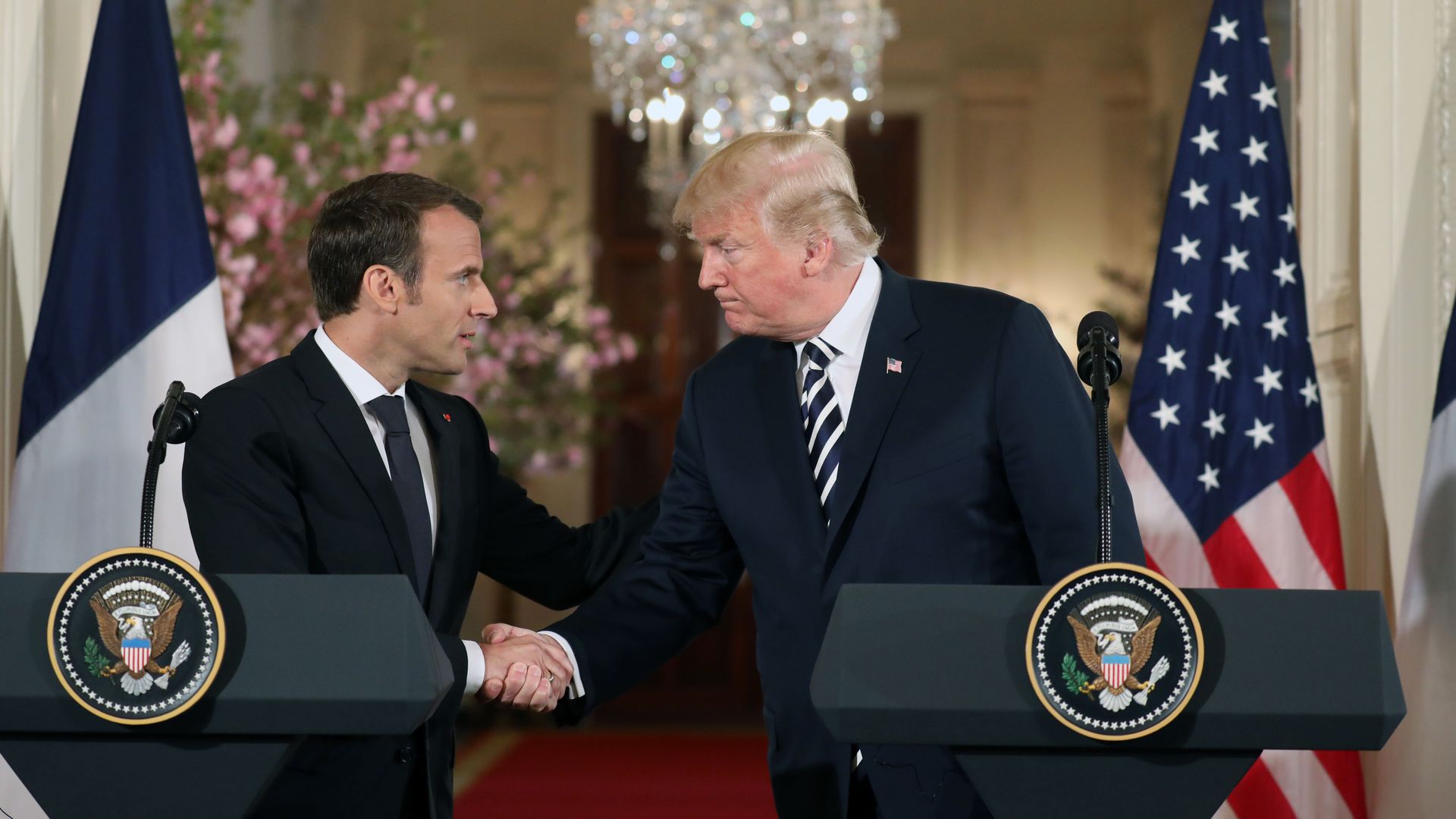 President Trump and French President Emmanuel Macron shake hands before a joint press conference at the White House