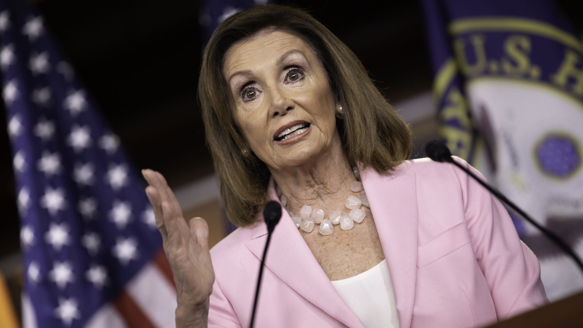 Nancy Pelosi speaks while gesturing with her right hand