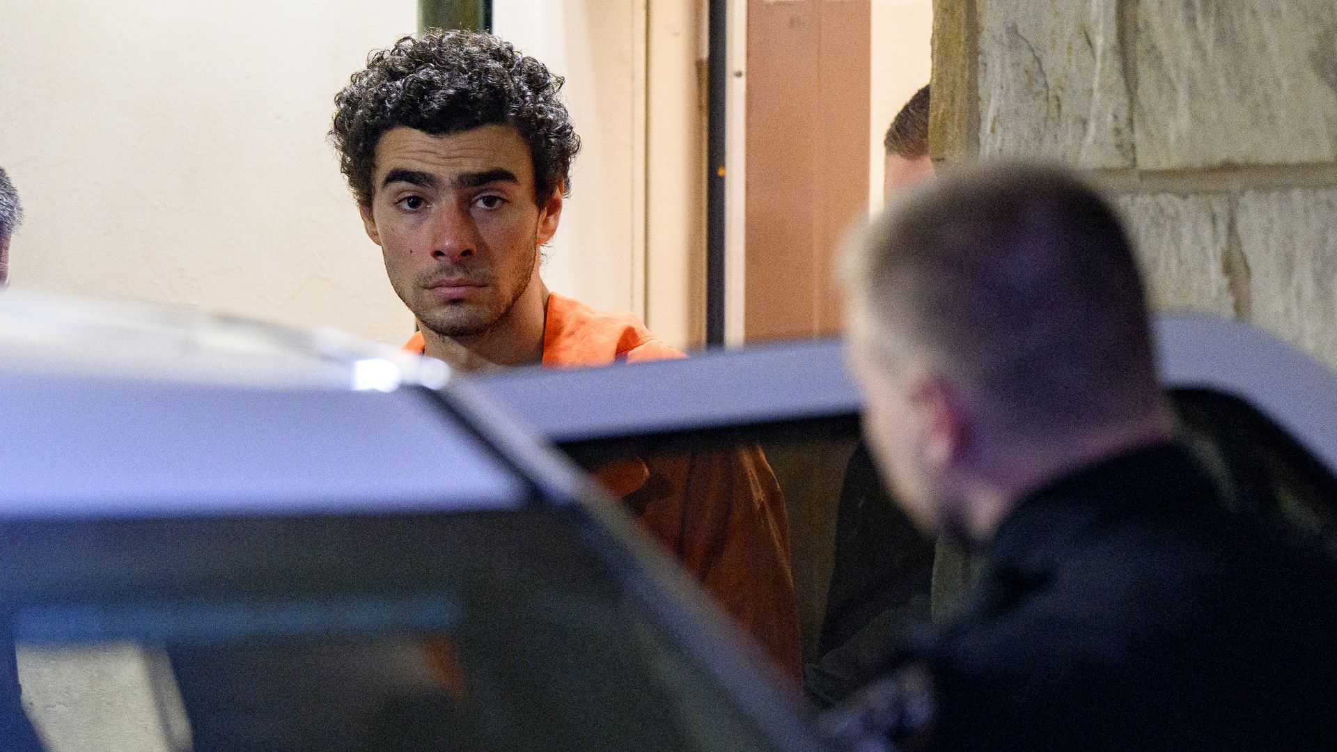 Suspected shooter Luigi Mangione is led from the Blair County Courthouse after an extradition hearing December 10, 2024 in Hollidaysburg, Pennsylvania. Mangione has been arraigned on weapons and false identification charges related to the fatal shooting of United Healthcare CEO Brian Thompson in NYC