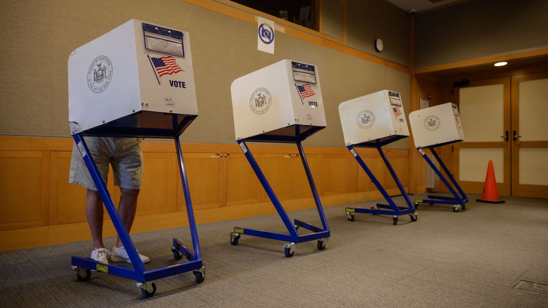 A voter stands in a booth at a voting station at the Metropolitan Museum of Art (MET) during the mayoral election process in New York 