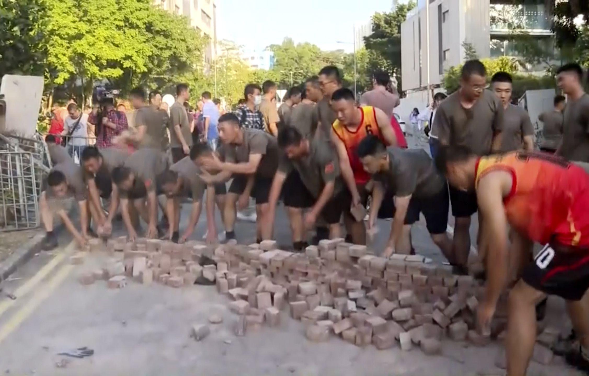 Troops picking up bricks.