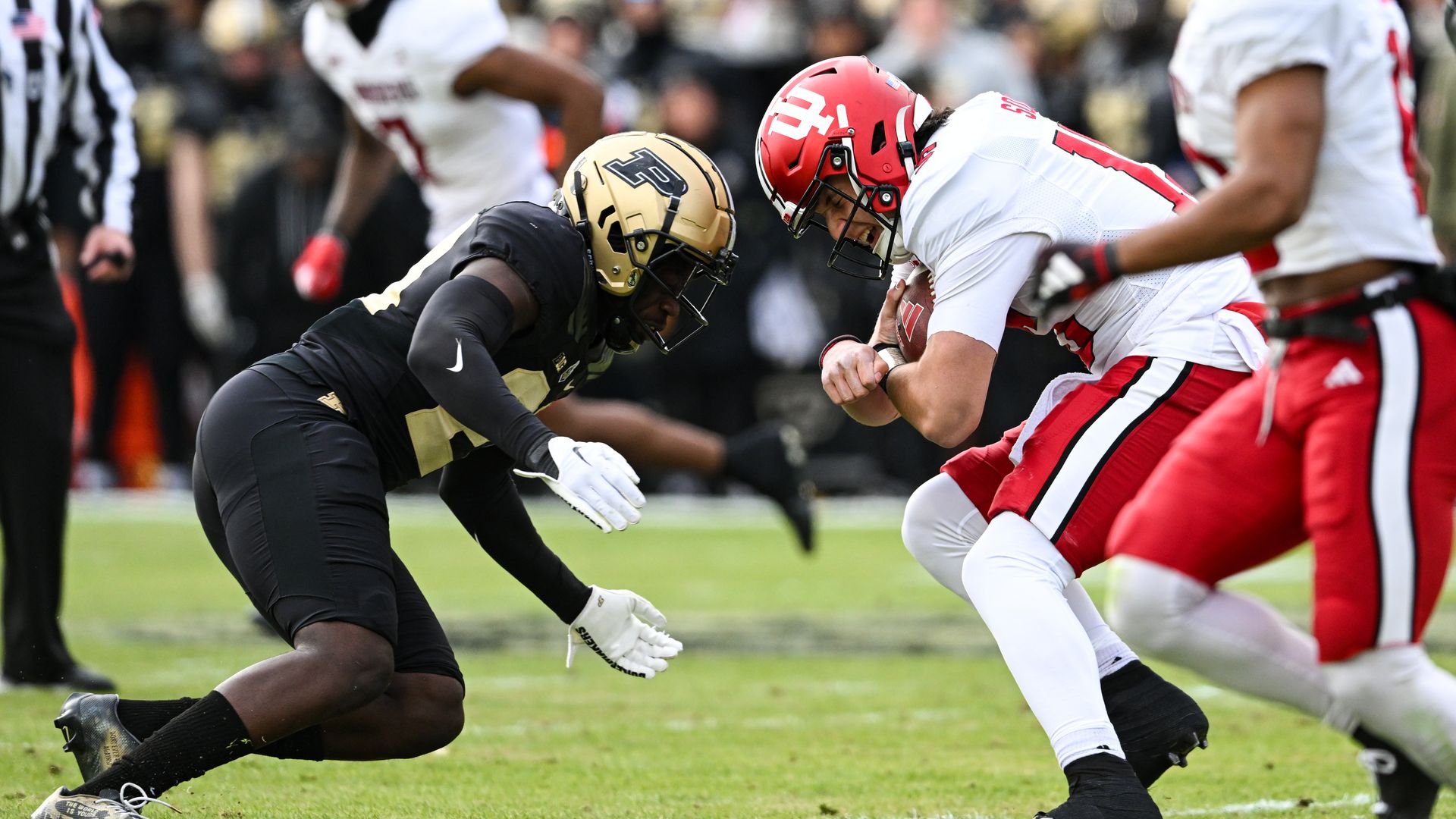 Purdue DB Sanoussi Kane (21) tackles Indiana QB Brendan Sorsby (15) during a college football game between the Indiana Hoosiers and Purdue Boilermakers on November 25, 2023 at Ross-Ade Stadium in West Lafayette, IN.