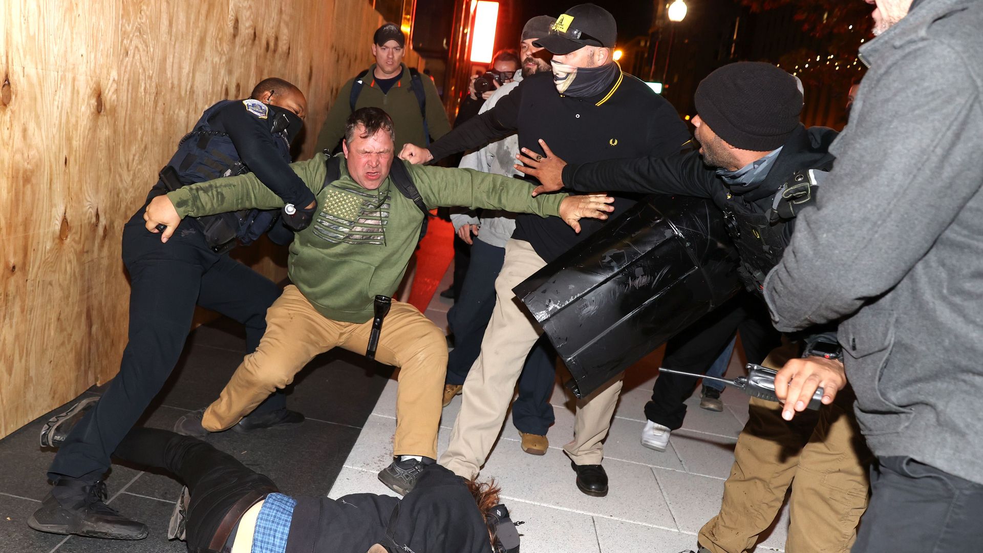 An officer tries to break up a fight between Black Lives Matter protesters and members of the Proud Boys on Nov. 14 in D.C.