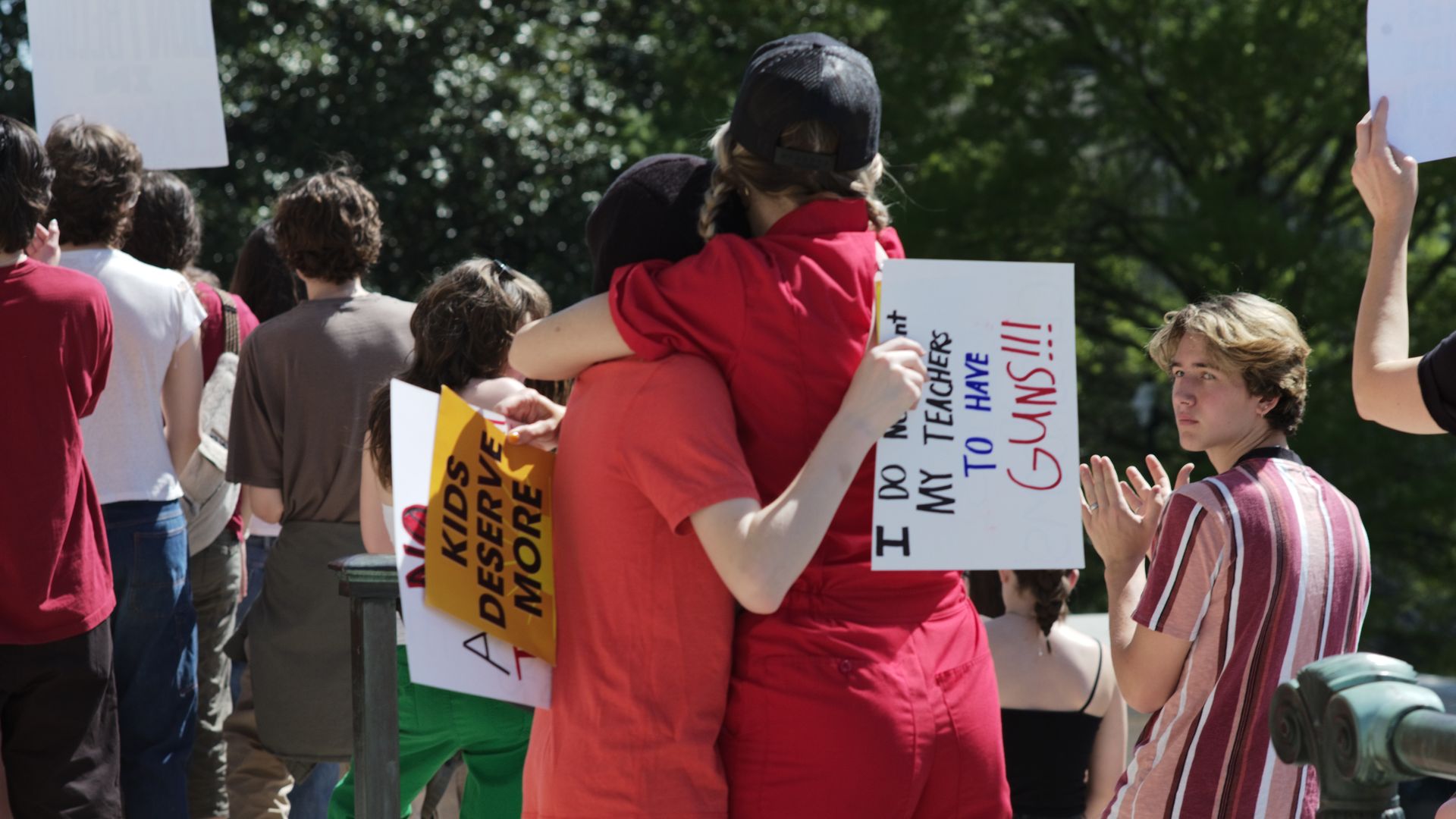 Two people hugging at an anti-gun protest.