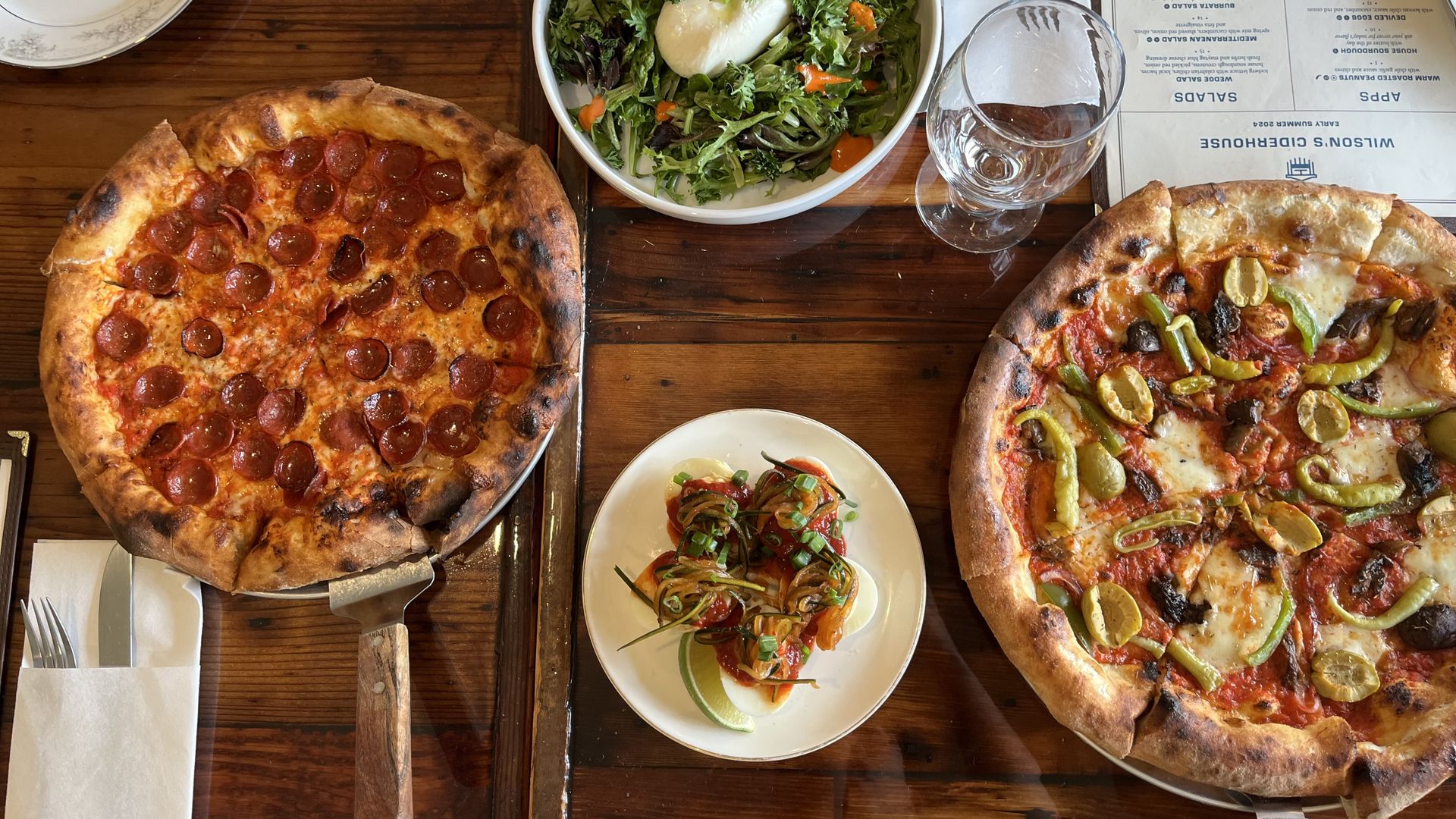 Pizzas, fancy deviled eggs and a salad on a table