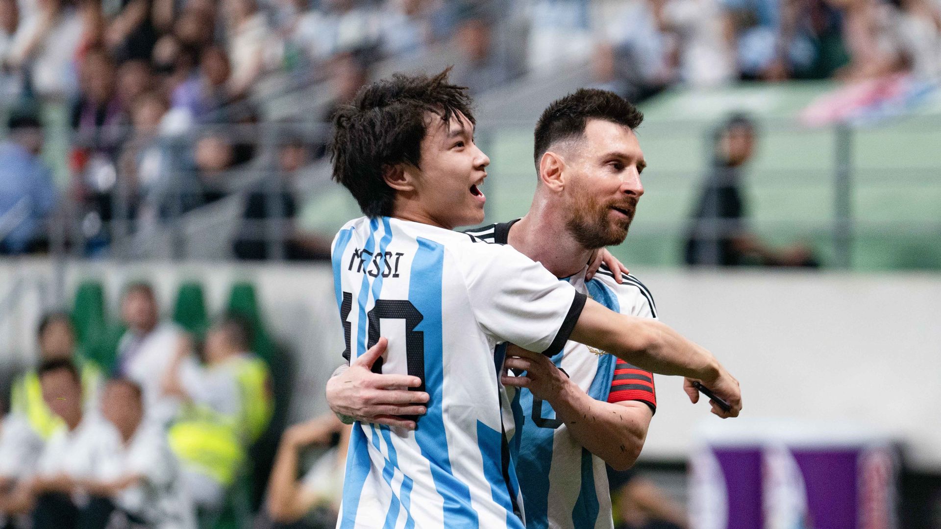 A pitch-invading fan L hugs Lionel Messi of Argentina during an international football invitational between Argentina and Australia in Beijing, capital of China, June 15, 2023. (Photo by Xie Han/Xinhua via Getty Images)