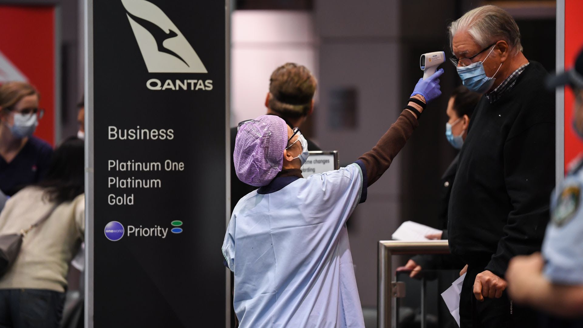 A nurse checks the temperature of a passenger arriving in Sydney airport. Photo: James D. Morgan/Getty Images