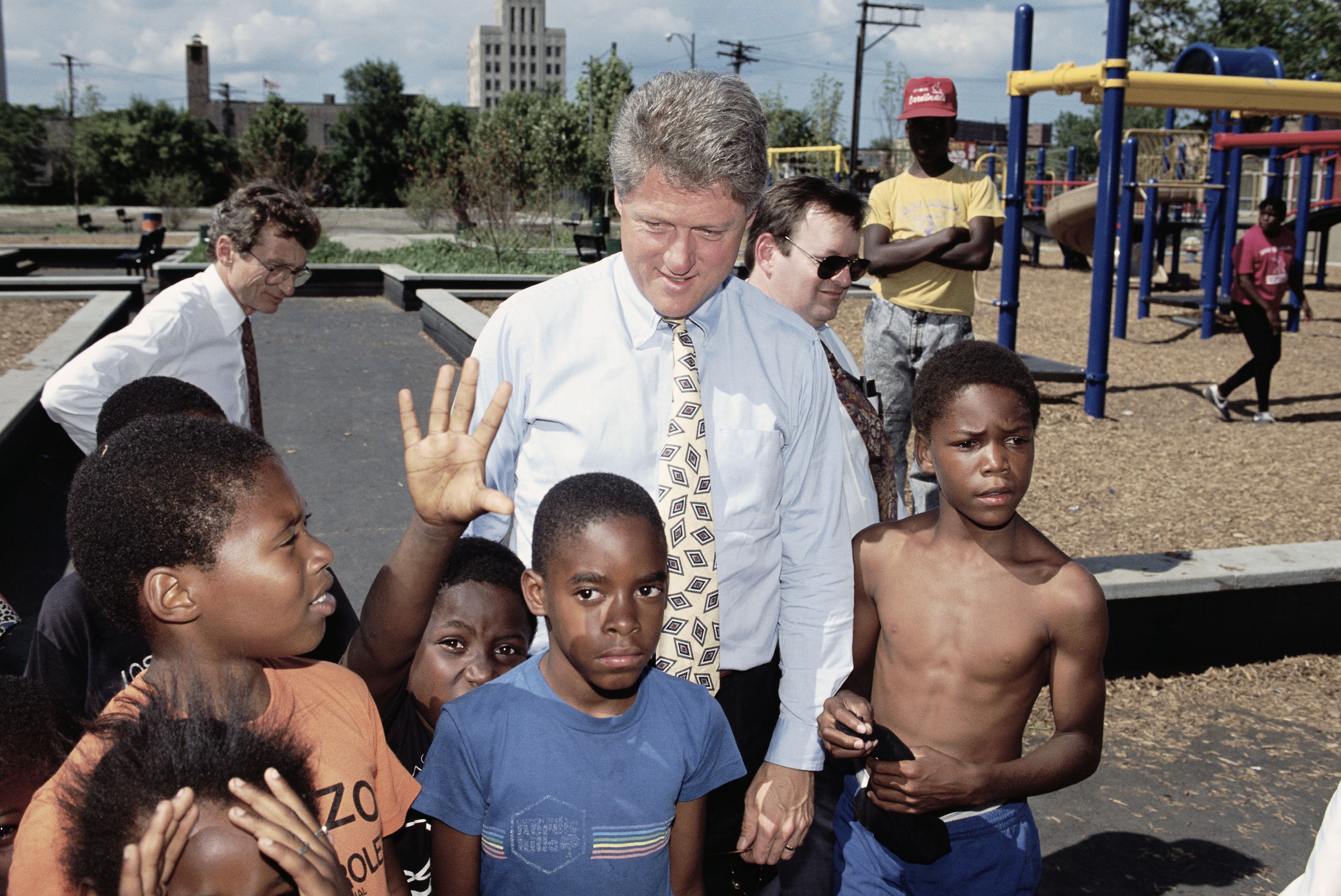 Photo of man surrounded by kids.