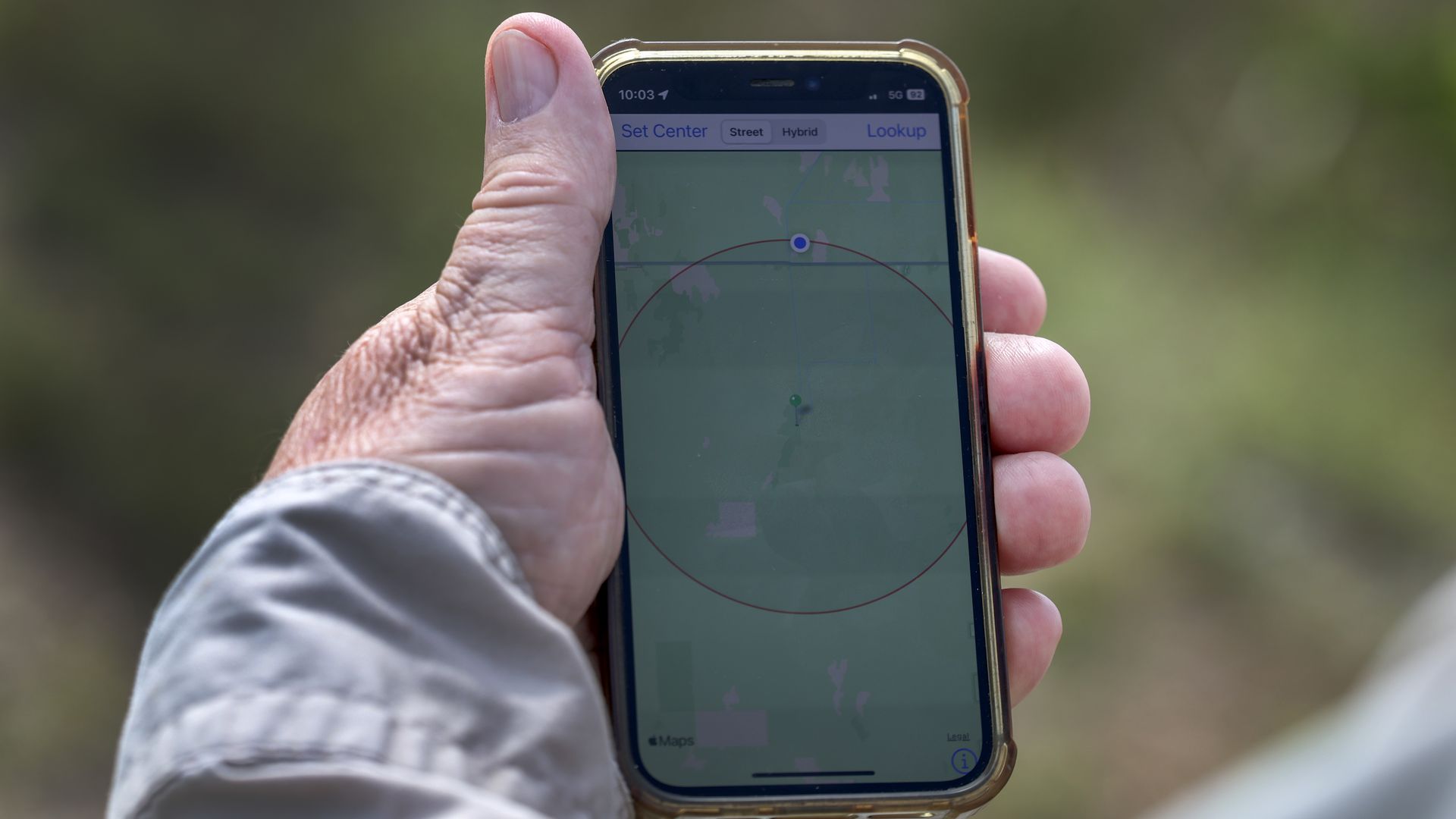 A hand holding a cell phone