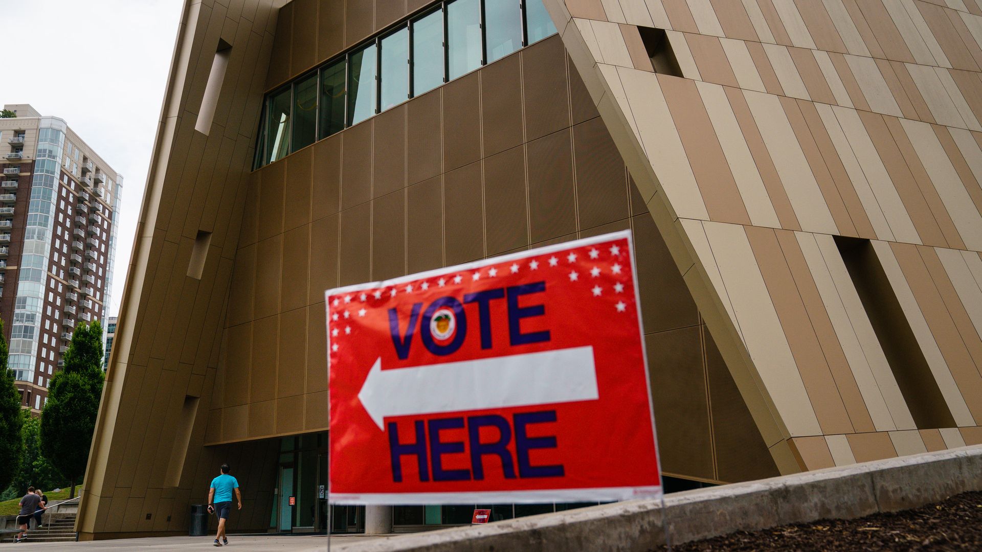 Photo of a "Vote here" sign outside a building