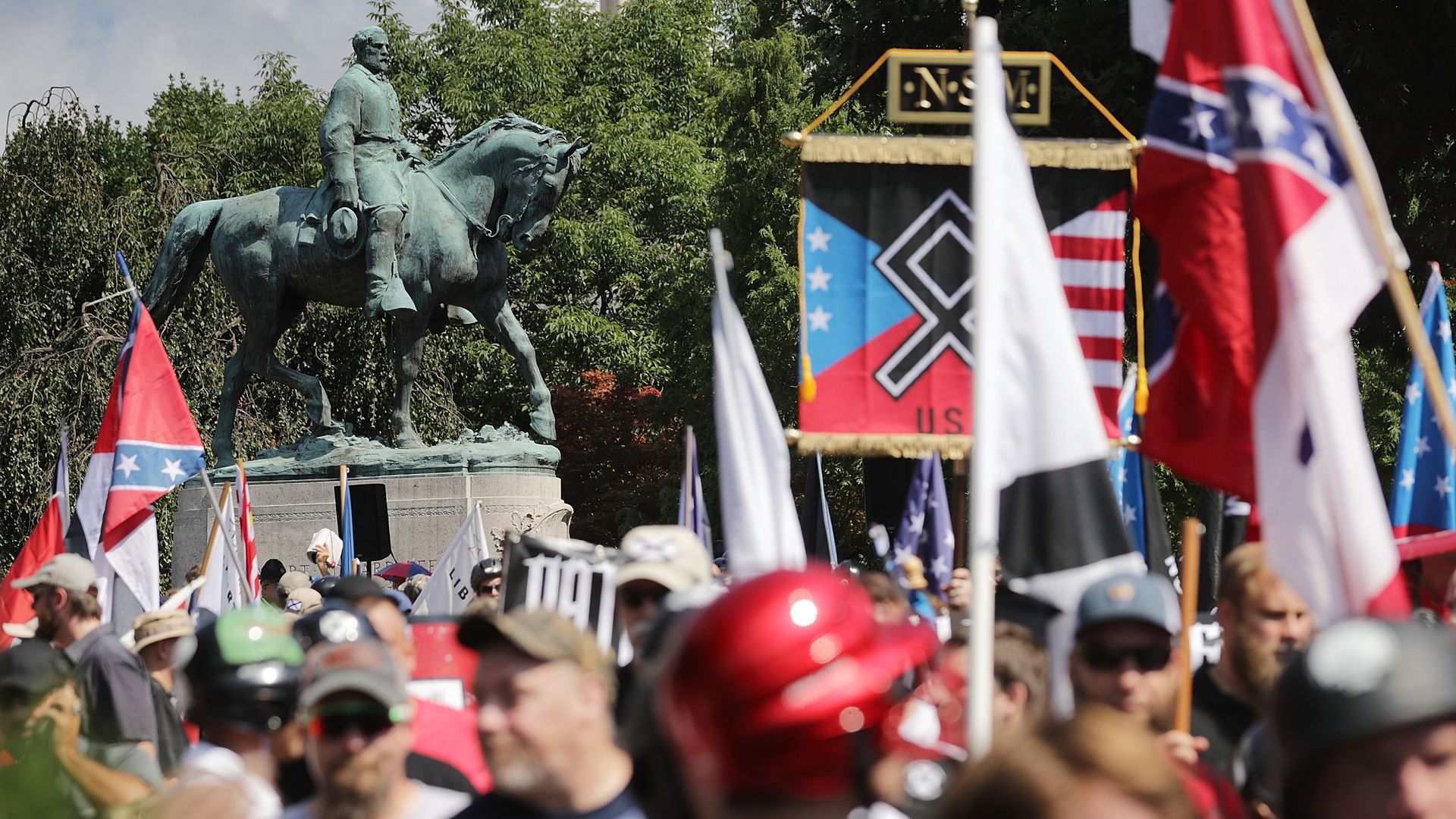 Protestors in Charlottesville in front of a confederate statue 