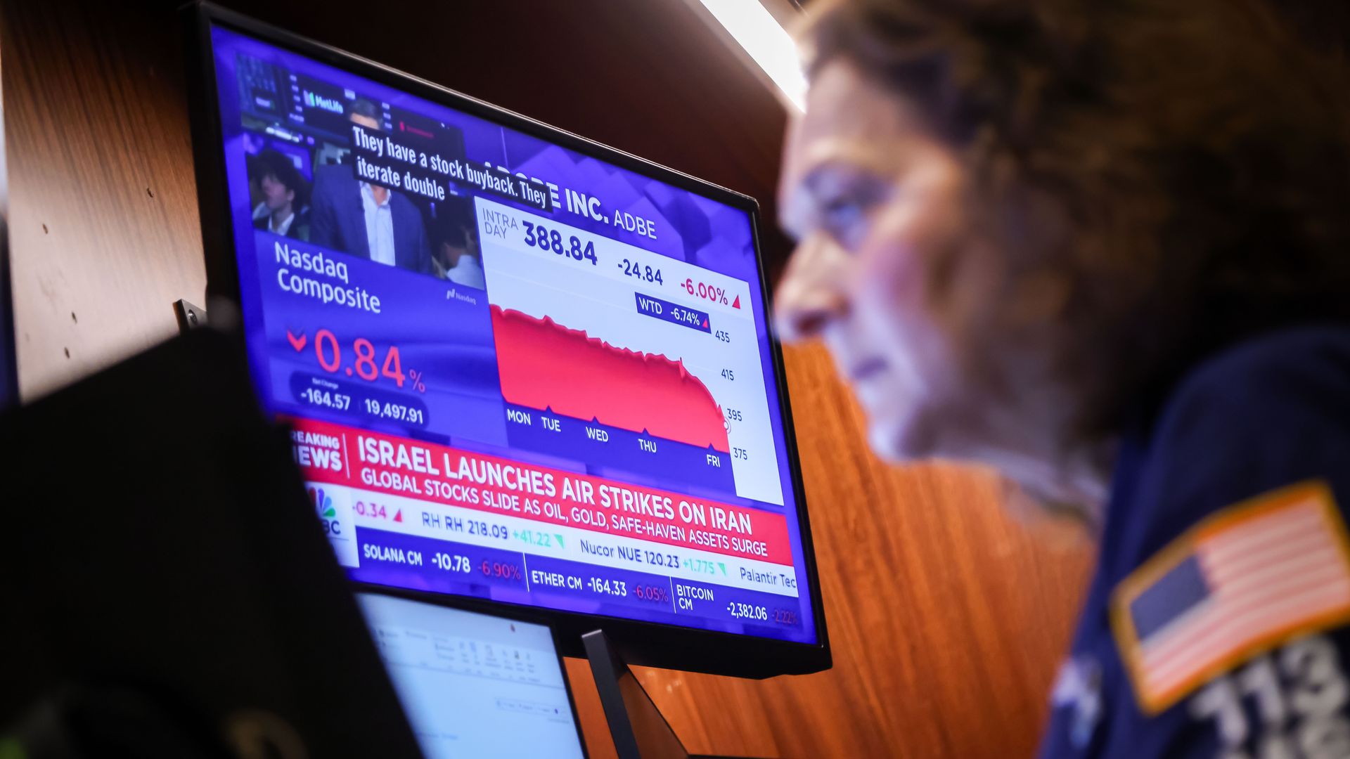 A TV broadcasts news on Israel's strike on Iran at the New York Stock Exchange.