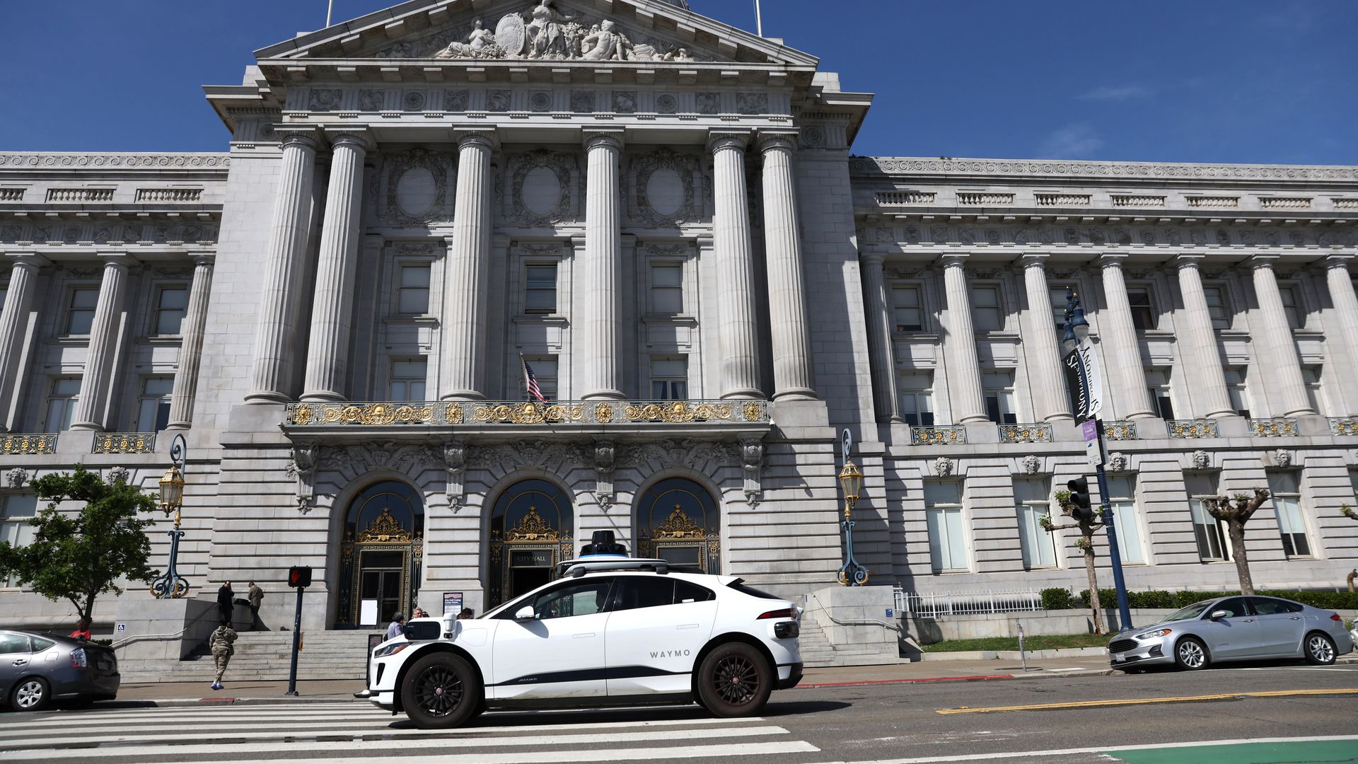 waymo car in front of city hall
