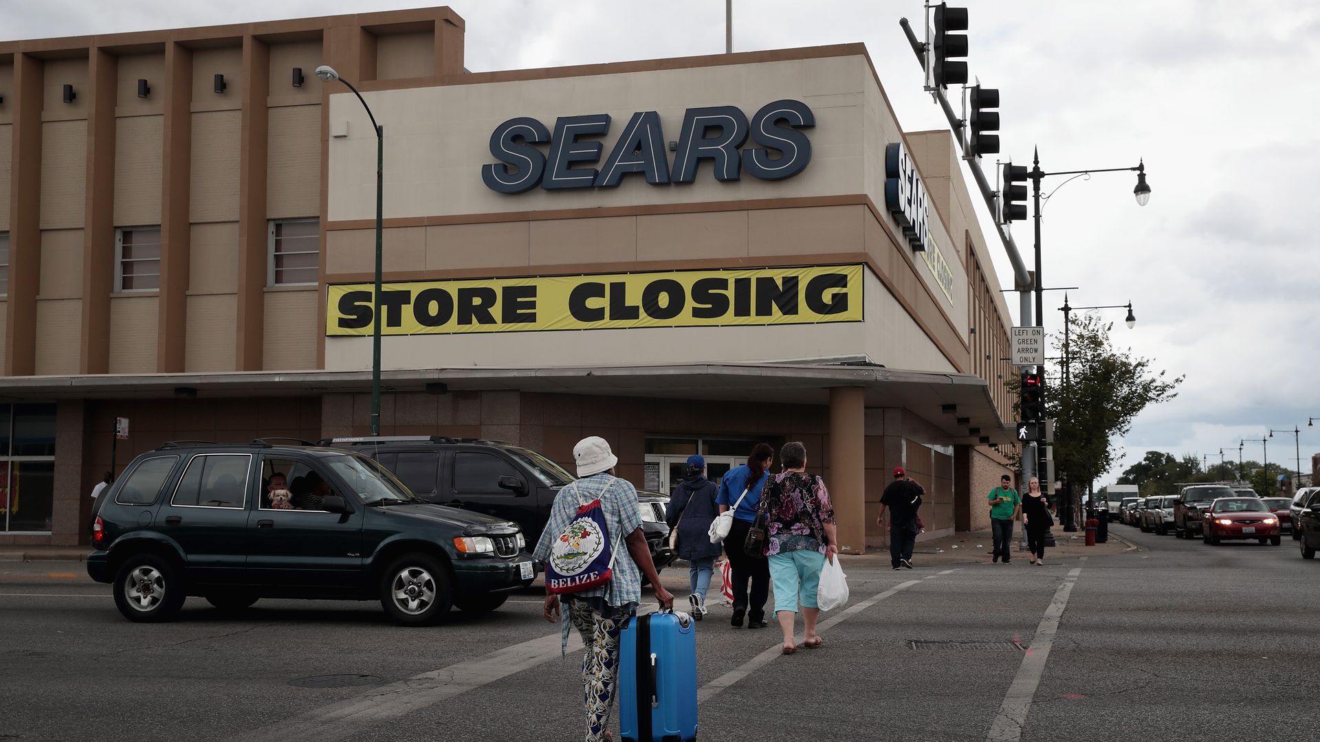 A Sears store with a "store closing" sign out front.