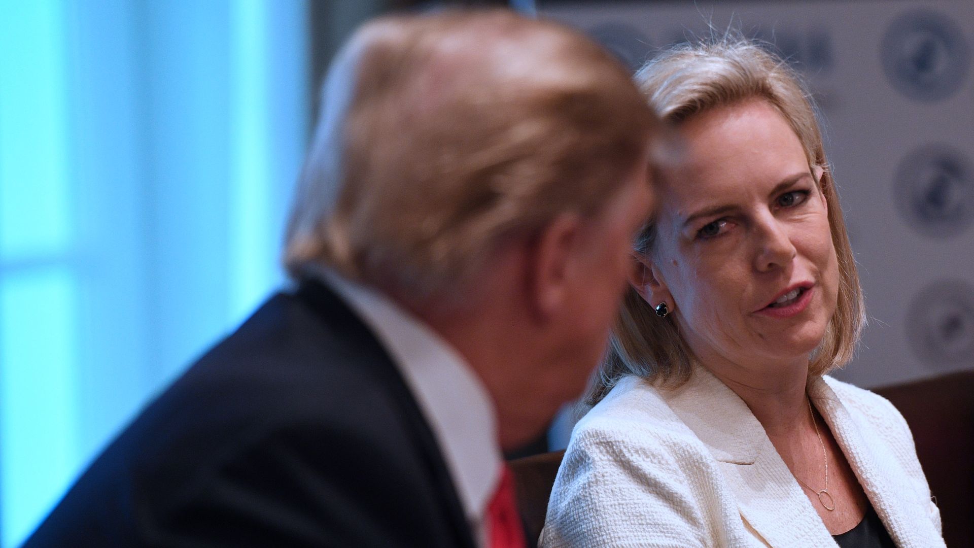 Secretary of Homeland Security Kirstjen Nielsen speaks to President Donald Trump.