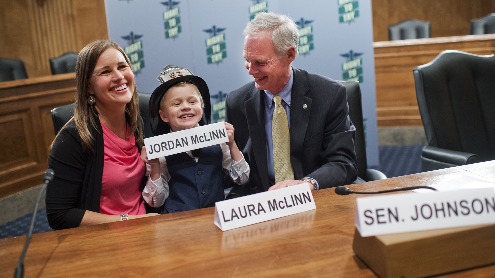 Sen. Ron Johnson with a mother and small child advocating for "right to try."